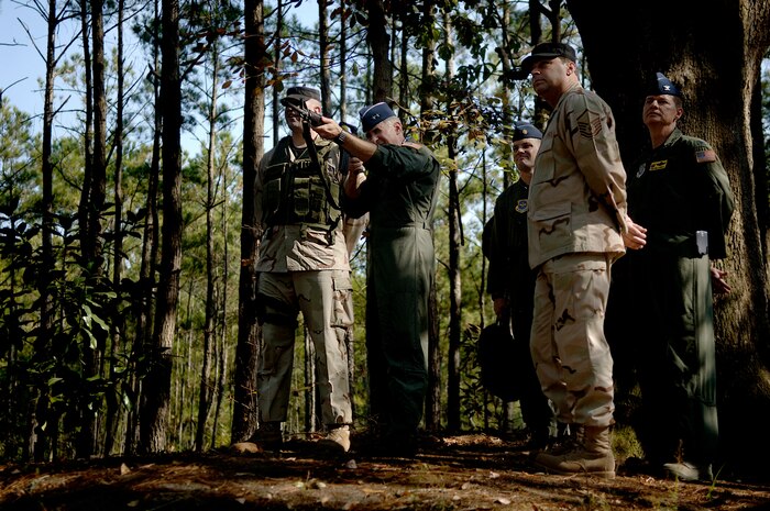 Maj. Gen. James Hawkins, 18th Air Force commander, shoots a simunitions round at a target at the Ability to Survive and Operate training area where the 437th Security Forces Squadron trains Airmen to be ready in the field. (U.S. Air Force photo/Senior Airman Nicholas Pilch)