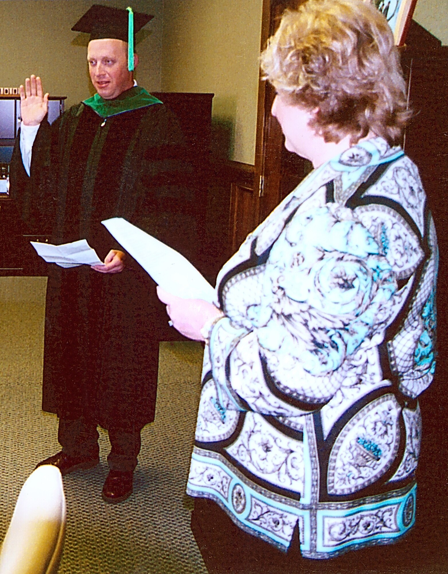 Taking the Osteopathic Oath, Tech. Sgt. Scott Avery becomes Doctor Scott Avery in the offices of Dr. Sandra Willsie (right), dean of the College of Osteopathic Medicine, Kansas City University of Medicine and Biosciences.  Sergeant Avery, a weapons loader and Air Force Reservist from the 442nd Fighter Wing, graduated from medical school in September 2007. (Courtesy photo)