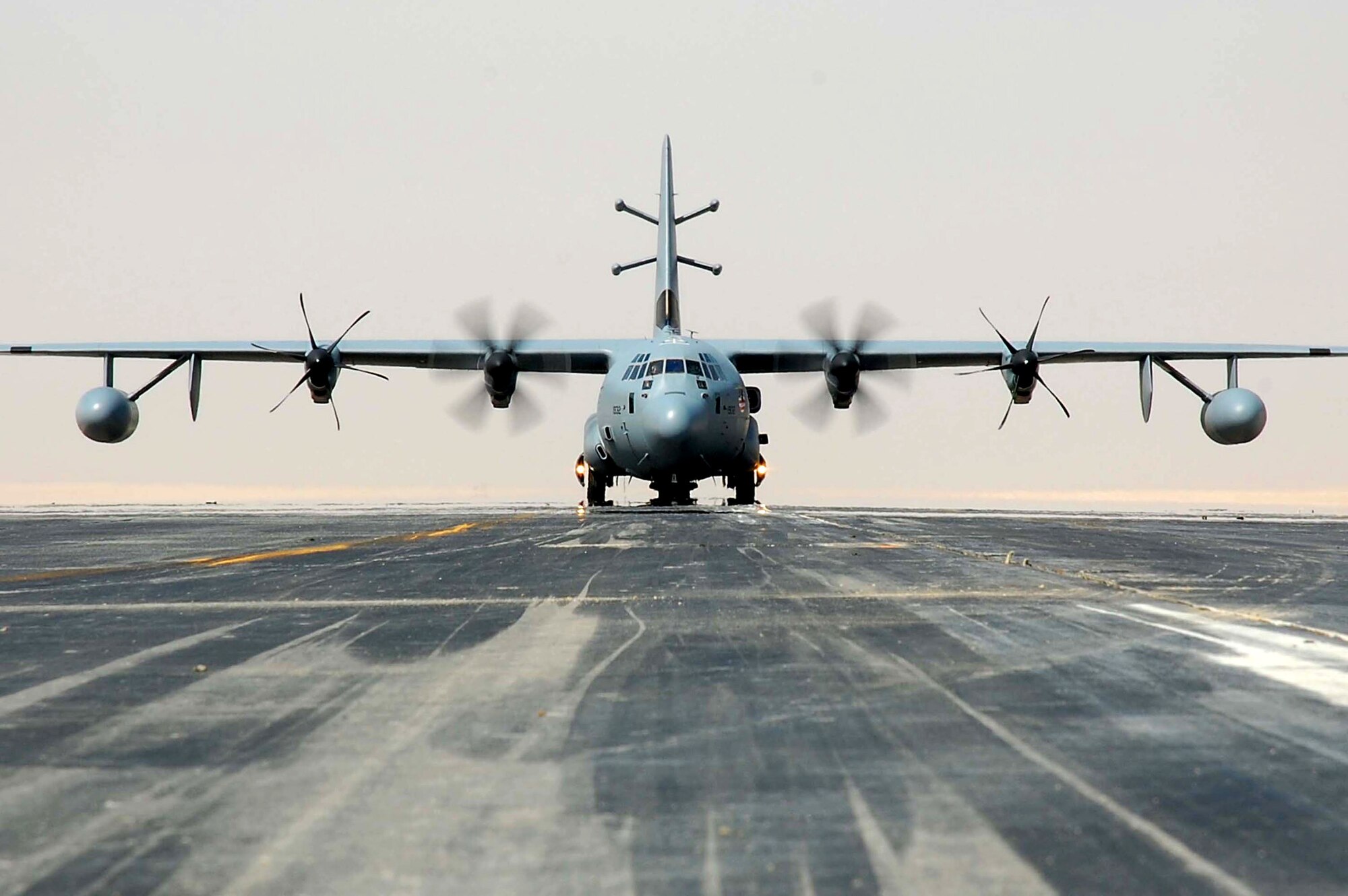 An EC-130J Commando Solo aircraft taxis down the runway from a base in Southwest Asia. The EC-130J conducts information operations and civil affairs broadcasts in AM, FM, HF, TV and military communications bands in support of Operation Enduring Freedom and Operation Iraqi Freedom. (U.S. Air Force photo/Staff Sgt. Tia Schroeder)
