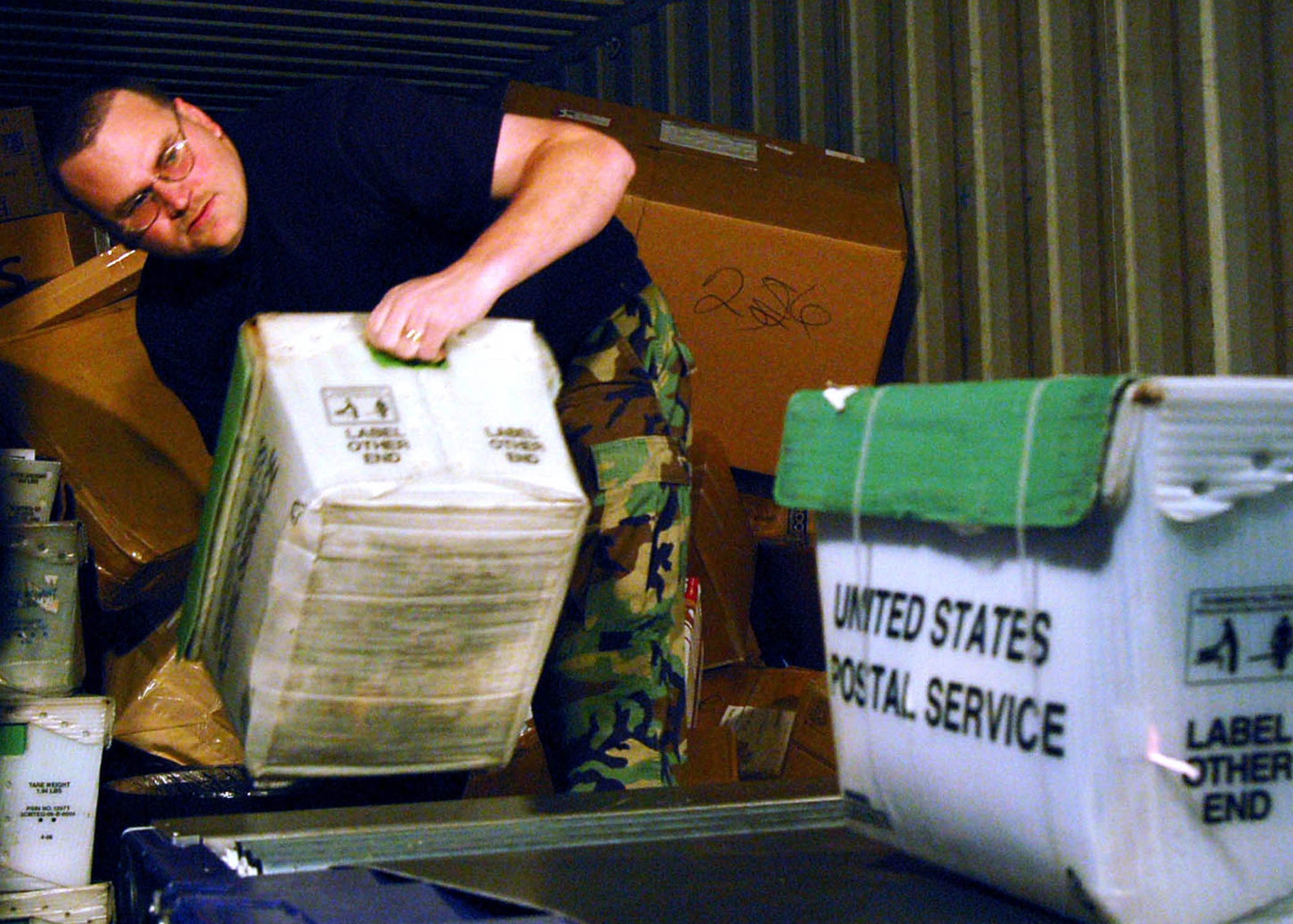 SPANGDALHEM AIR BASE, Germany –Staff Sgt. Royce Johnson, 52nd Communications Squadron, unloads a mail truck at the Spangdahlem Air Base post office Nov. 19. All Airmen are members of the 52nd Communications Squadron post office staff. During the holiday season, the approximately 35 person staff of postal Airmen, augmentees, civilians and volunteers process, stock, label and disseminate more than 1.2 million pounds of mail. (U.S. Air Force photo/Staff Sgt. Tammie Moore)