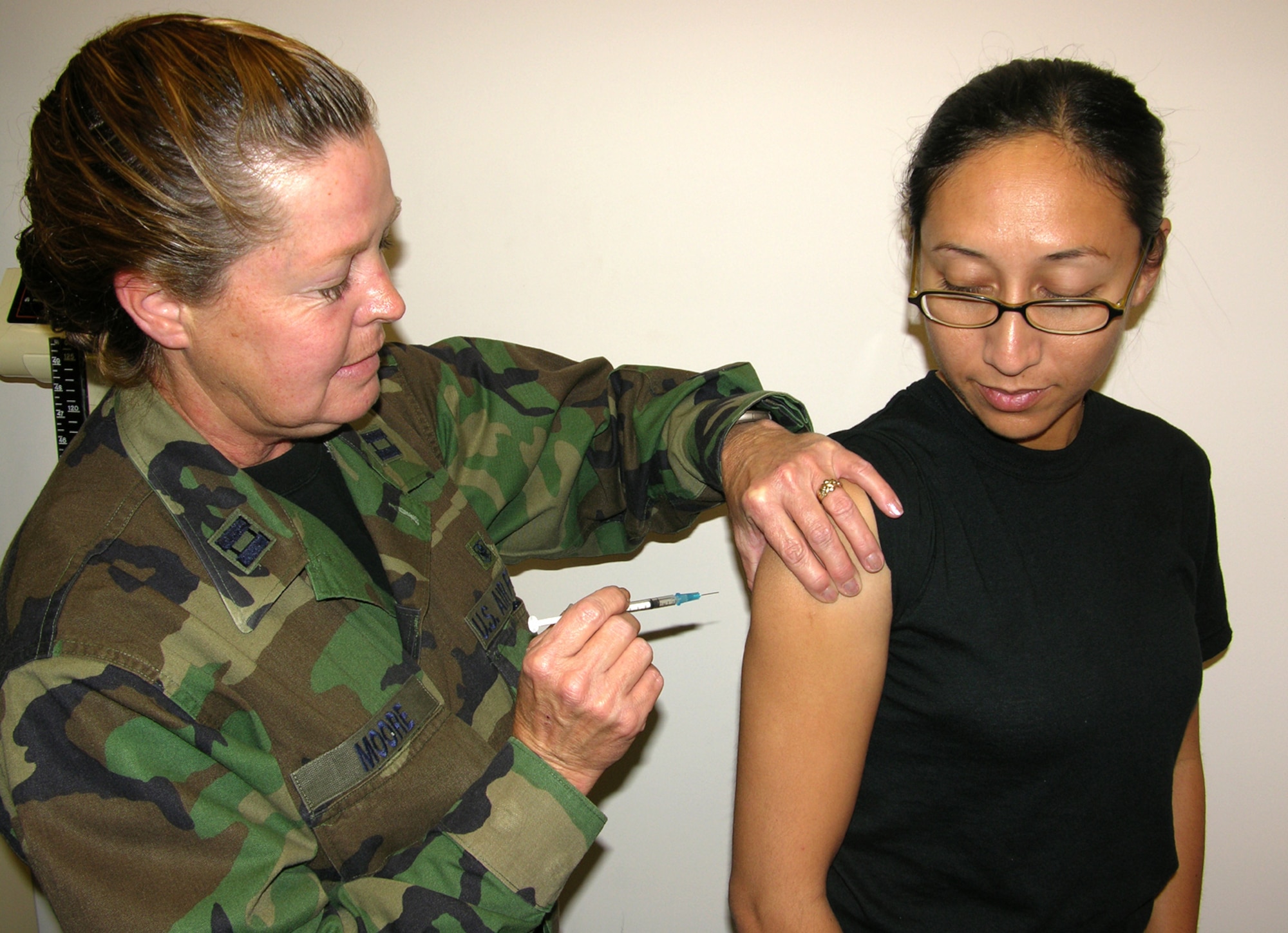 SEYMOUR JOHNSON AIR FORCE BASE, N.C. --Capt. Debra K. Moore, the officer in charge of immunizations at the 916th Air Refueling Wing's medical flight, administers the new HPV vaccine to Tech. Sgt. Kamille J. Resetz. The vaccine, called Gardasil, is available to women under age 26. 