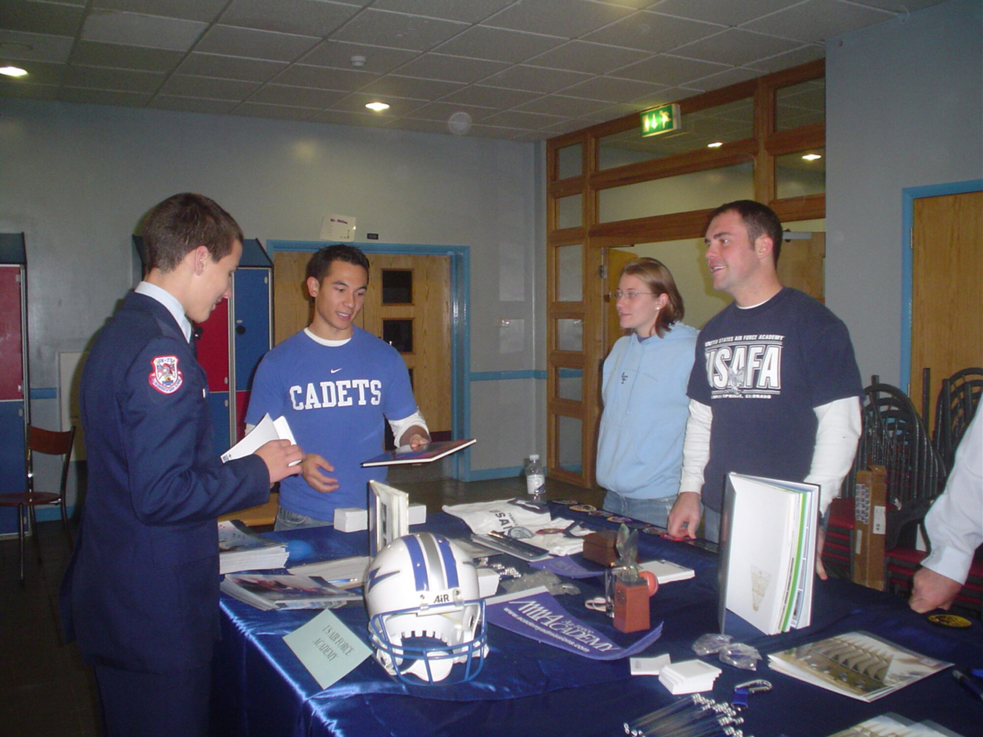 Representatives from the U.S. Air Force Academy, Co., speak with a Lakenheath High School Junior Reserve Officers Training Corps cadet about their experiences at the Academy during the annual College Fair at Lakenheath High School, Nov. 14.  The purpose of the event was to provide students with information on post secondary education options, which is vitally important to the children of U.S. service members living abroad, saving them the expenses of having to take trips back to the United States to visit colleges and universities.  Nearly 60 people volunteered to represent their alma maters for the two-hour event, and more than 400 students and parents attended the event to receive firsthand information on the 75 institutions of higher learning represented. (U.S. Air Force photo by Capt. Alysia Harvey)
