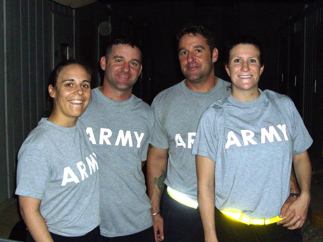 (Left to right) Capt. Alicia Pruitt; her husband, Capt. Joseph Pruitt; his brother, Chief Warrant Officer Michael Pruitt; and his wife, Capt. Kristi Pruitt, pose for a photo at Camp Striker, Baghdad. U.S. Army photo