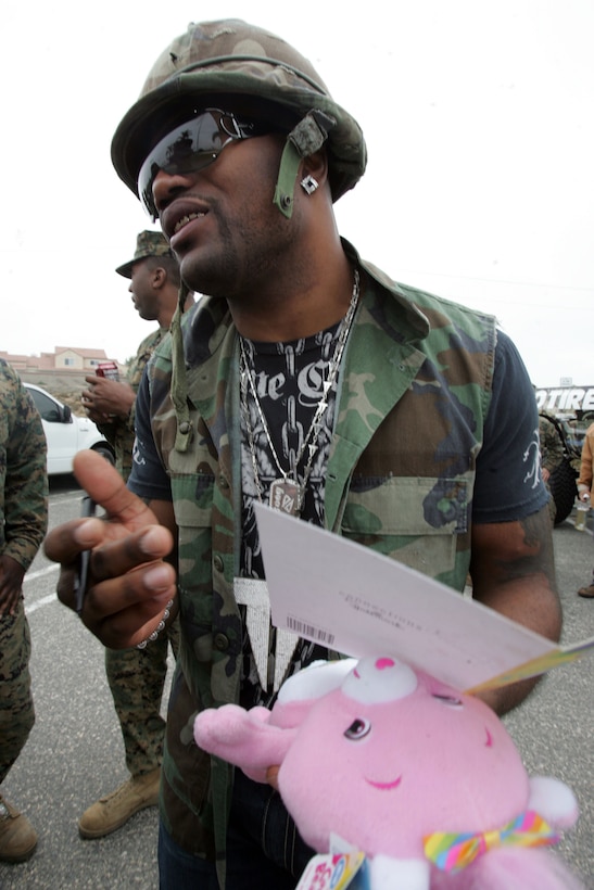 Ultimate Fighting Championship light heavyweight champion Quinton ?Rampage? Jackson prepares to sign a teddy bear and a greeting card for a Marine at Camp Pendleton, Calif., Nov. 20. Jackson also signed autographs when he visited Marines in Camp Horno and Wounded Warrior Barracks West.