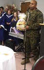 Maj. Robert Piper, executive officer, Chemical Biological Incident Response Force, II Marine Expeditionary Force, thanks the medical staff at Civista medical center for donating baskets of food here Nov. 20. The LaPlata High School Choir entertained during the ceremony with holiday music.