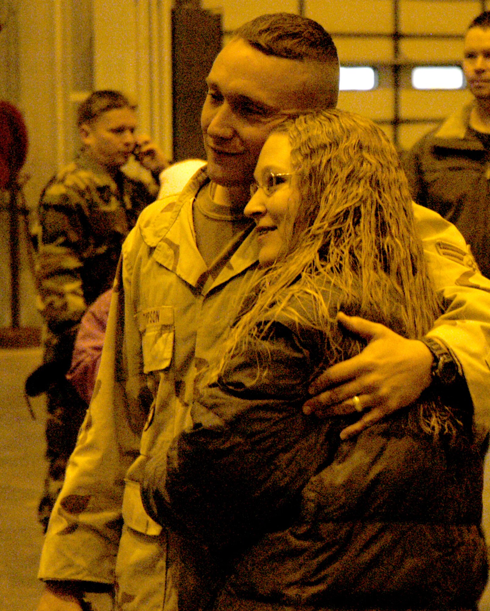 Staff Sgt. Robert Thompson, 790th Missile Security Forces Squadron, and his wife Heidi embrace after Sergeant Thompsons return Nov. 11. Sergeant Thompson was one of 18 Warren members sent to train Iraqi police (Photo by Tech. Sgt. Kurt Arkenberg).