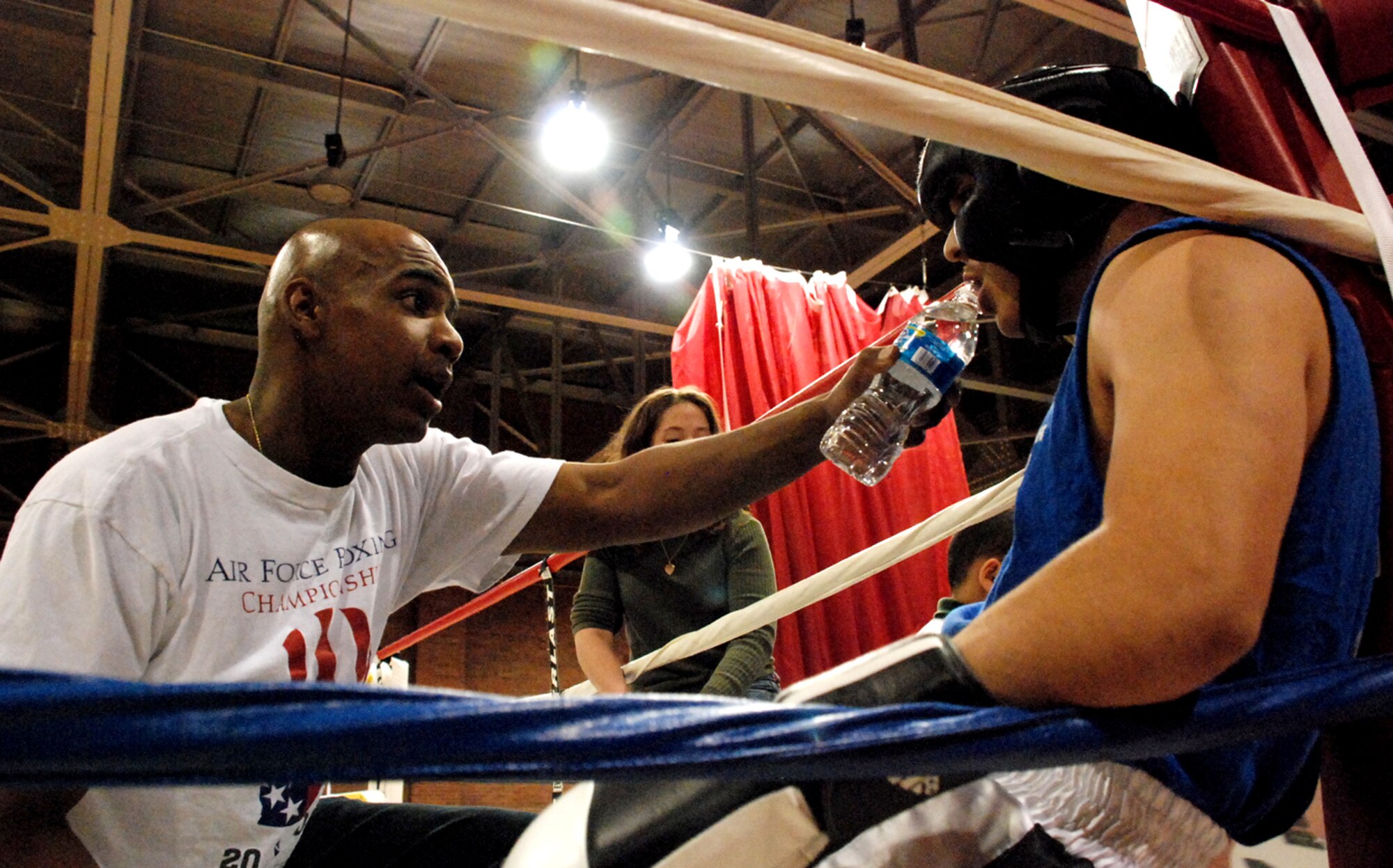 Capt. Rod Ellison, 319th Missile Squadron, coaches Jiarus Martinez, Cheyenne Boxing Club, during the exhibition Nov. 10 at the Fall Hall Community Center. Mr. Martinez sparred off against Airman 1st Class Kurtis Beunting, 90th Communications Squadron. Since some of the boxing matches were military members against civilians, there were no winners to the exhibition fights (Photos by Airman 1st Class Daryl Knee).