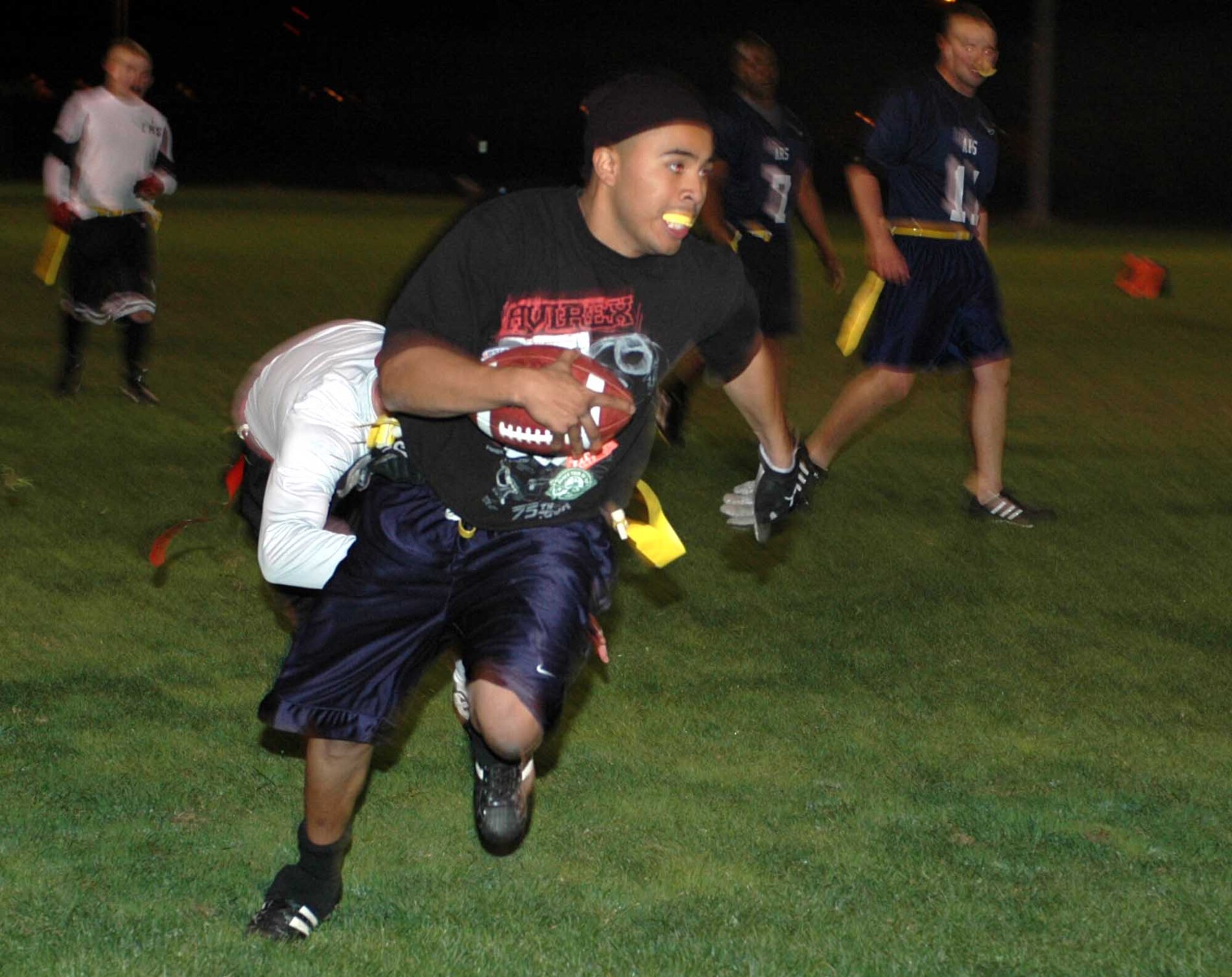Brandon Chavez, Travis Gold All-Stars’ halfback, runs for a 40-yard gain during the Intramural Flag Football All-Star Classic Nov. 20. Chavez had 95 total rushing yards and an interception return for a touchdown. The Red All-Stars defeated the Gold All-Stars 14-12. (U.S. Air Force photo/Staff Sgt. Candy Knight)