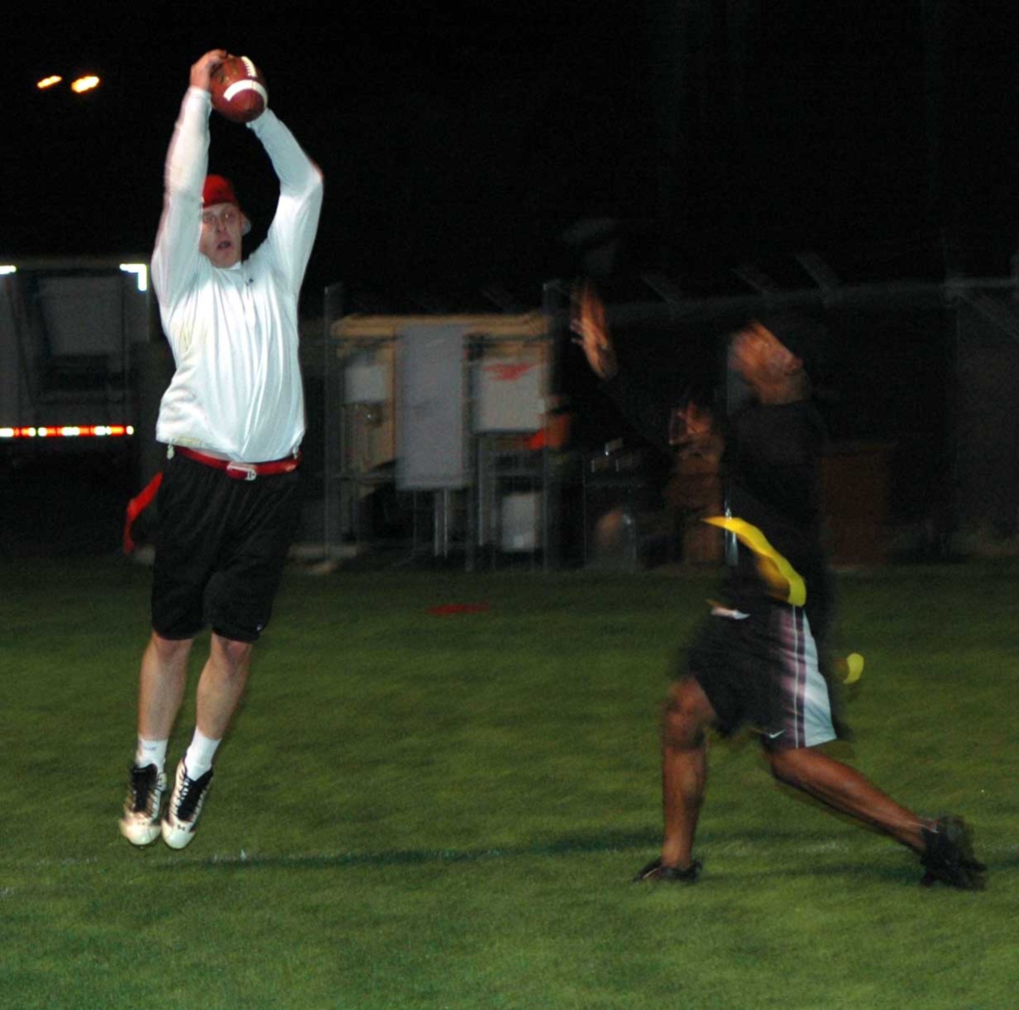 James Wilson, (white shirt), Travis Red All-Stars’ wide receiver, catches a pass over Joseph Harris, Travis Gold All-Stars’ cornerback during the Intramural Flag Football All-Star Classic Nov. 20. The Red All-Stars defeated the Gold All-Stars 14-12. (U.S. Air Force photo/Staff Sgt. Candy Knight)