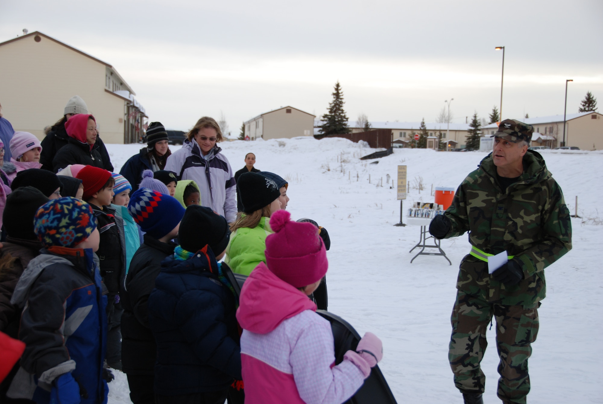 EIELSON AIR FORCE BASE, Alaska-- Col. Brian Maas, 354th Fighter Wing deputy commander, speaks to more than 300 Anderson Elementary School students as they anticipate the ribbon cutting of the new sled hill on base, during a ceremony Nov. 20 behind the school. The sled hill is located in the boundaries of Eielson AFB, however the land it sits on is owned by the Fairbanks North Star Borough and Eielson received permission to move the old sled hill to the new location. Contractors who helped build the hill from the earth in the old hill are: Great Northwest Inc., MWH, and DGR. (U.S. Air Force photo by Airman 1st Class Nora Anton)