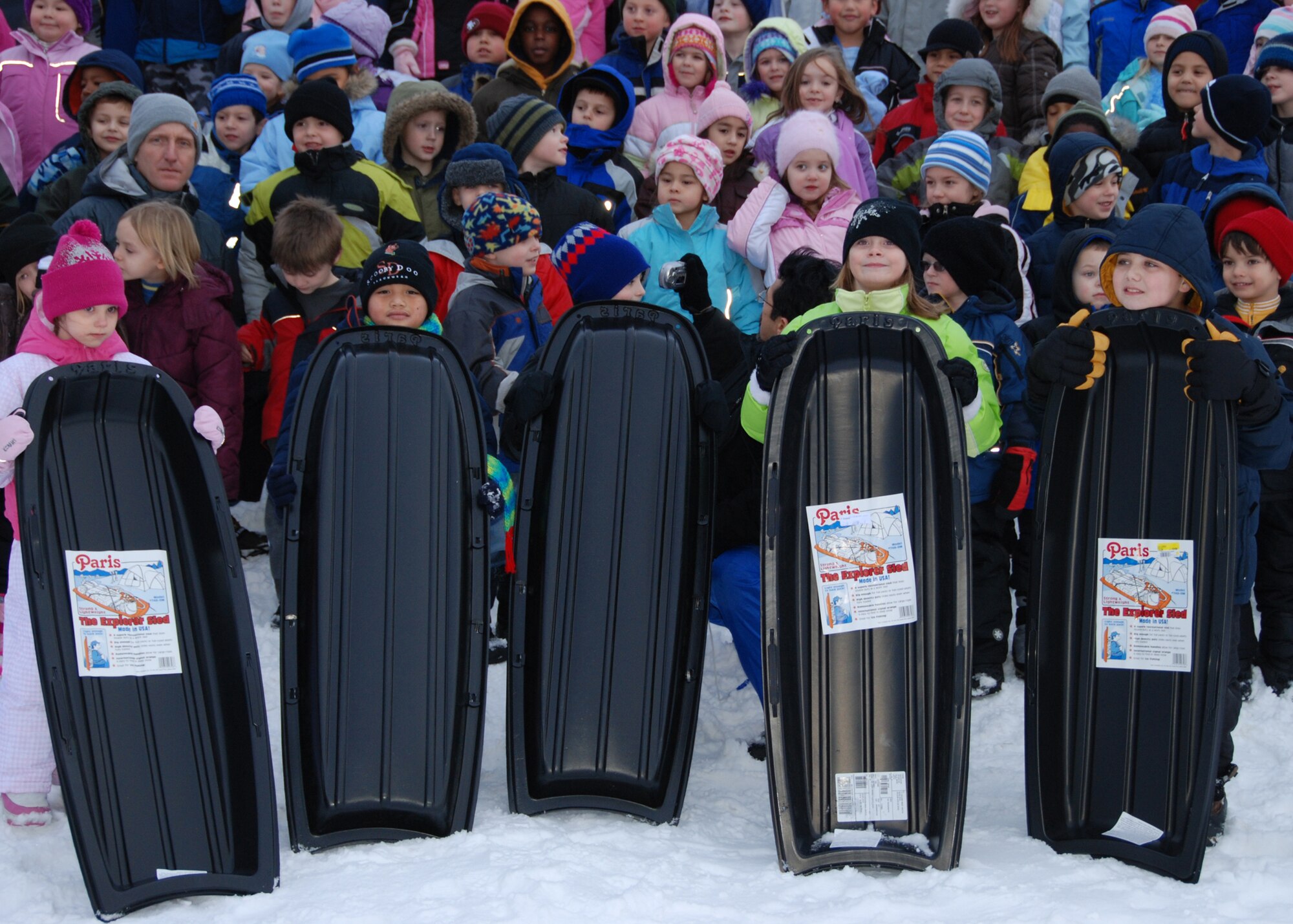 EIELSON AIR FORCE BASE, Alaska-- The five sled winners, Breanna Turner, Samuel Merrill, Rino Mathews, Alexis Thompson and Robert Ragan, await the ribbon cutting of the new sled hill during a ceremony Nov. 20 behind the school. Around 300 students came to participate, receiving a speech from Col. Brian Maas, 354th Fighter Wing deputy commander, and enjoying juice and cookies. The hill was relocated behind the school on what is legally property of the Fairbanks North Star Borough, who gave Eielson permission to put the hill there. (U.S. Air Force photo by Airman 1st Class Nora Anton)
