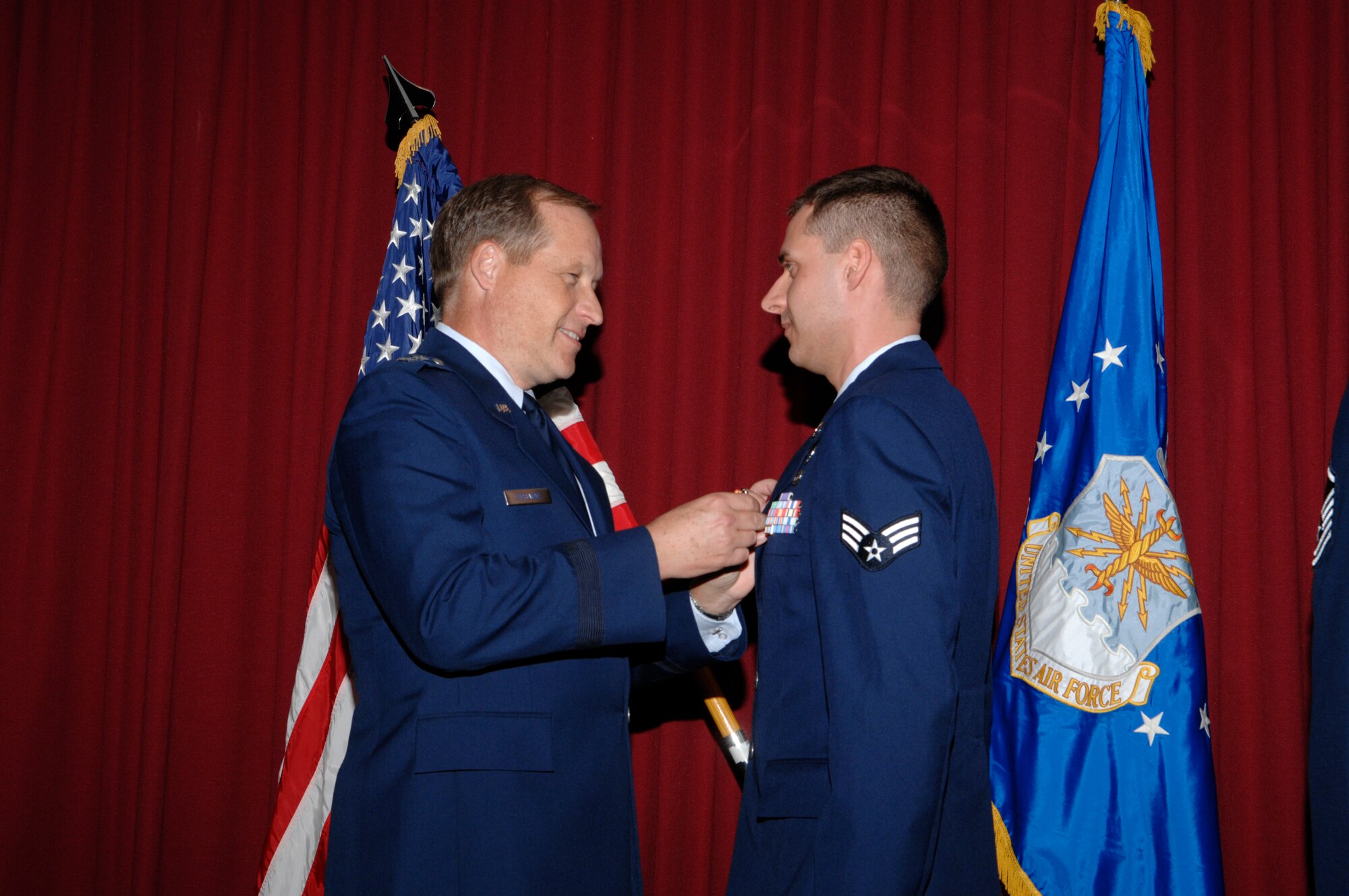 EGLIN AIR FORCE BASE, Fla. -- Maj. Gen. David Eidsaune, Air Force Program Executive Officer for Weapons and Air Armament Center commander, awards Senior Airman Aaron Jones the Air Force Combat Action Medal Nov. 20, for his actions while deployed to Iraq. Airman Jones is assigned to the 96th Civil Engineer Squadron explosive ordnance disposal flight. (U.S. Air Force photo)