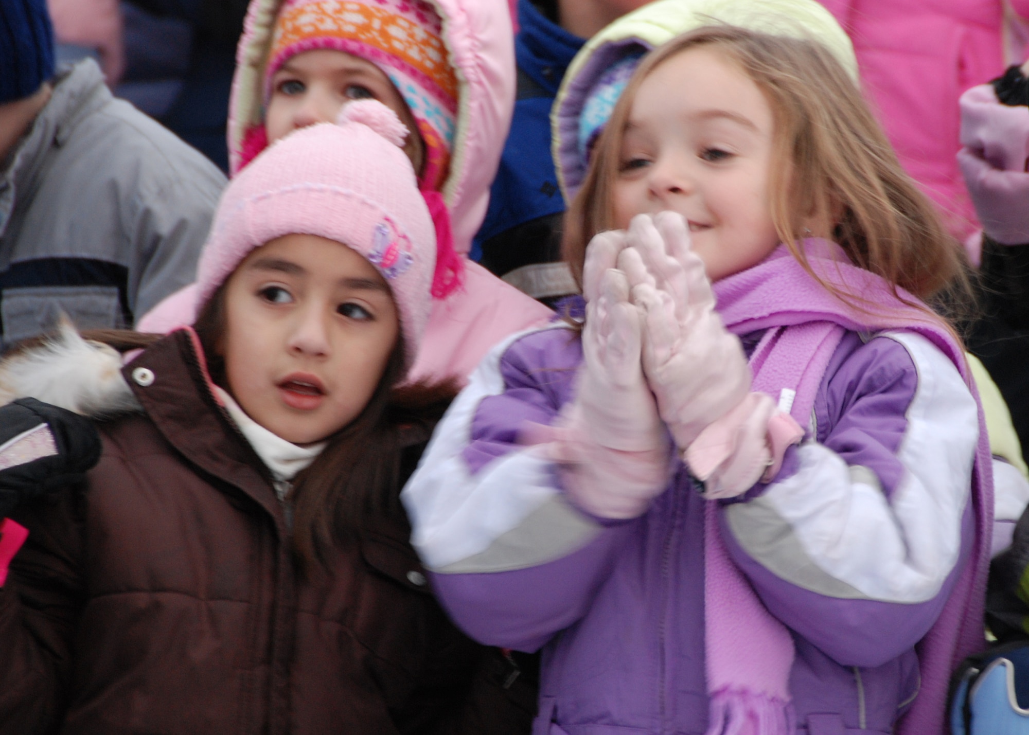 EIELSON AIR FORCE BASE, Alaska-- Two Anderson Elementary School students anticipate the ribbon-cutting to officially open the new sled hill located behind the school during a ceremony Nov. 20. Around 300 students came to participate, receiving a speech from Col. Brian Maas, 354th Fighter Wing deputy commander, enjoying juice and cookies and five sled winners got the priveledge of sledding down the hill. The hill was relocated behind the school on what is legally property of the Fairbanks North Star Borough, who gave Eielson permission to put the hill there. (U.S. Air Force photo by Airman 1st Class Nora Anton) 
