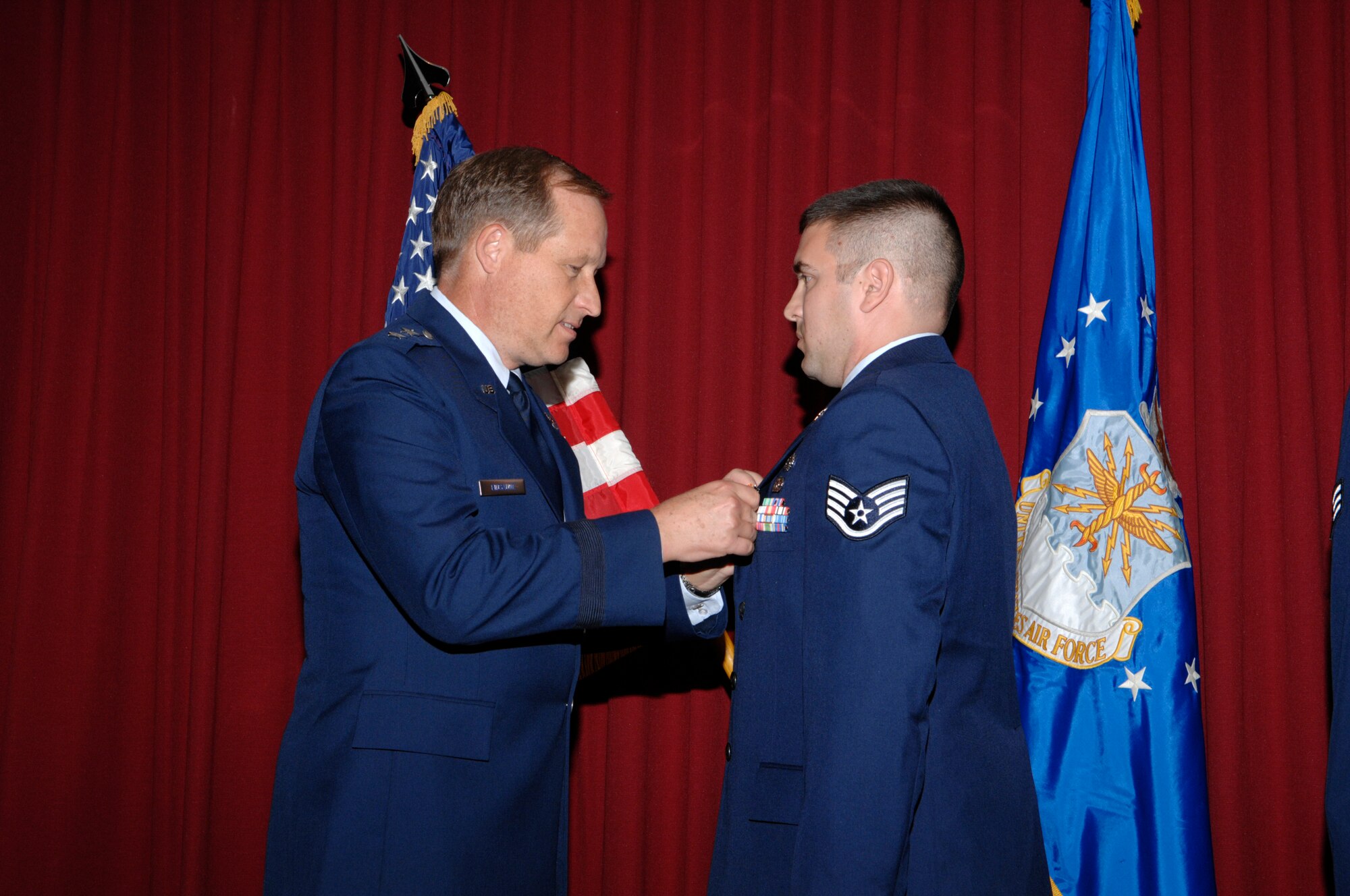 EGLIN AIR FORCE BASE, Fla. -- Maj. Gen. David Eidsaune, Air Force Program Executive Officer for Weapons and Air Armament Center commander, awards Staff Sgt. Ryan Otero the Air Force Combat Action Medal Nov. 20, for his actions while deployed to Iraq. Sergeant Otero is assigned to the 96th Civil Engineer Squadron explosive ordnance disposal flight. (U.S. Air Force photo)