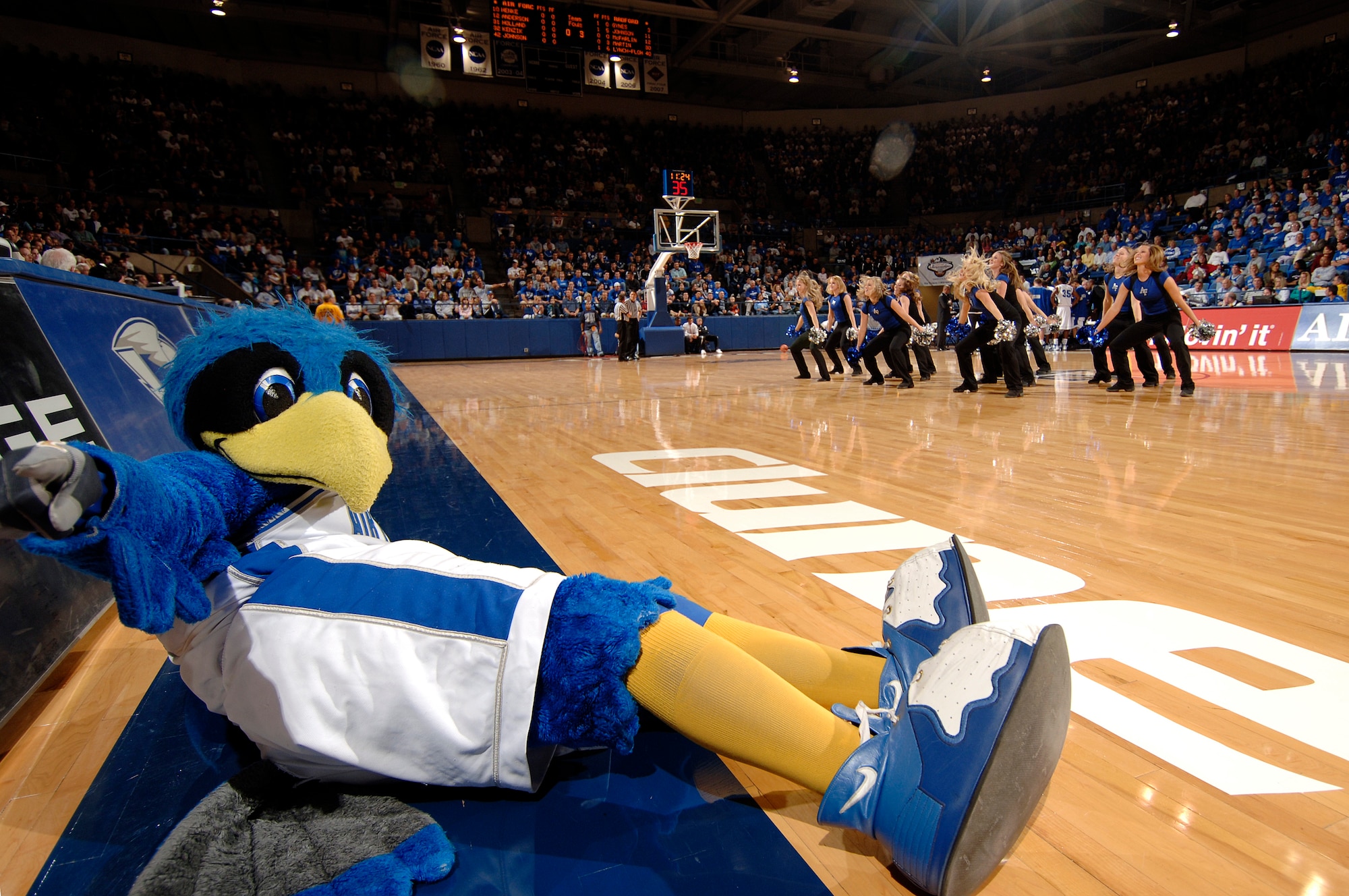 The Air Force Falcons' mascot, The Bird, slides while the Air Force dance team motivates the crowd during a time out at Clune Arena Nov. 19. The Air Force defeated the Radford Highlanders 52-47 in overtime.  Air Force, under first-year coach Jeff Reynolds, is 4-0 on the season.  (U.S. Air Force photo/Mike Kaplan)