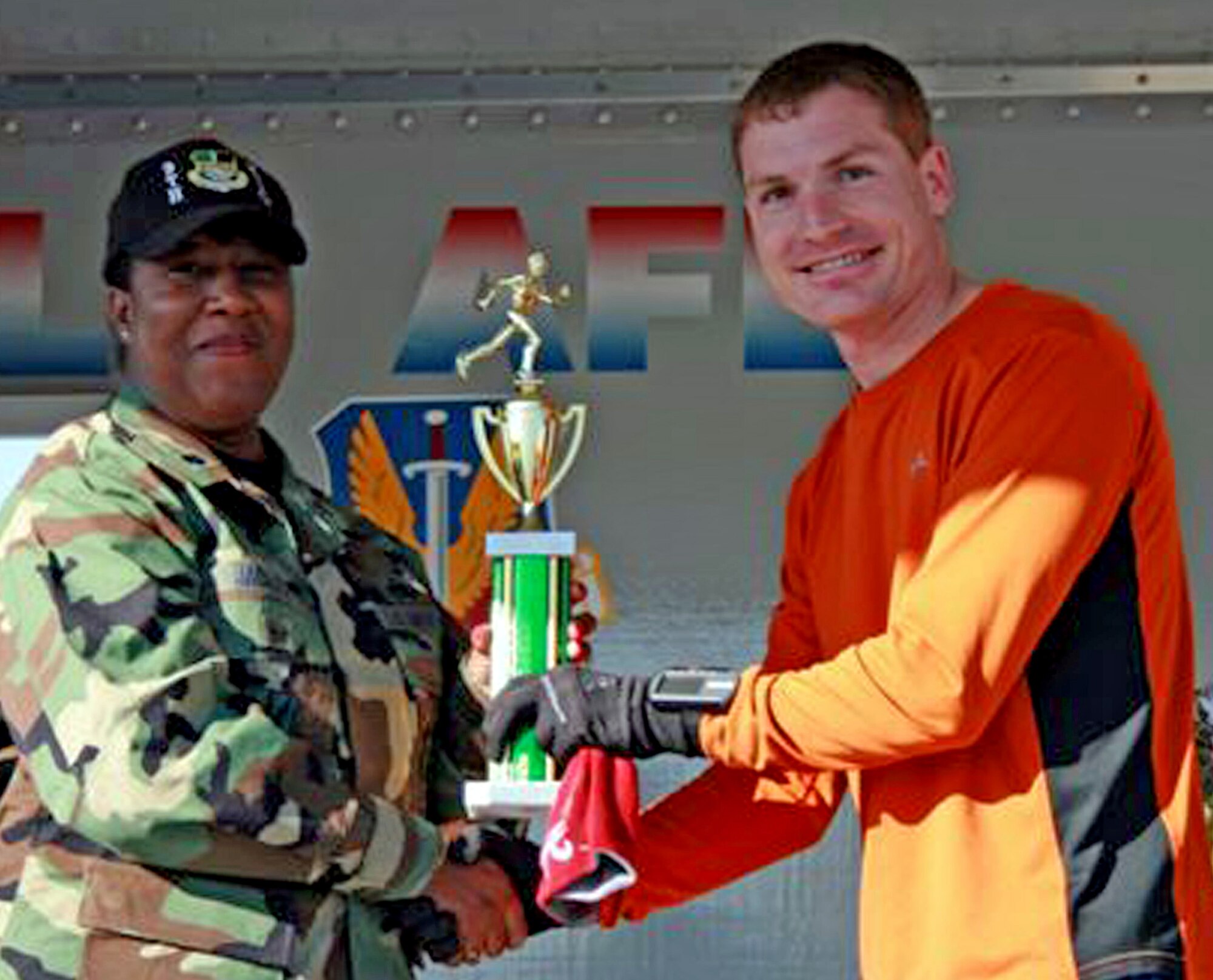 Capt. Brandon Stepp, an Air Force Reservist with the 940th Logistics Readiness Squadron, Beale Air Force Base, Calif., accepts his first place trophy after posting his best run time ever to win the Beale Recce Challenge Adventure Series 10K race. The captain finished first overall with a time of 42:30, saying, "It was by far, the best time of my life." This was his third time competing in this 9th Reconnaissance Services Squadron sponsored event. He began training for his first marathon while deployed to Kyrgyzstan in support of the global war on terror. (US Air Force photo/Tammy S Berard)