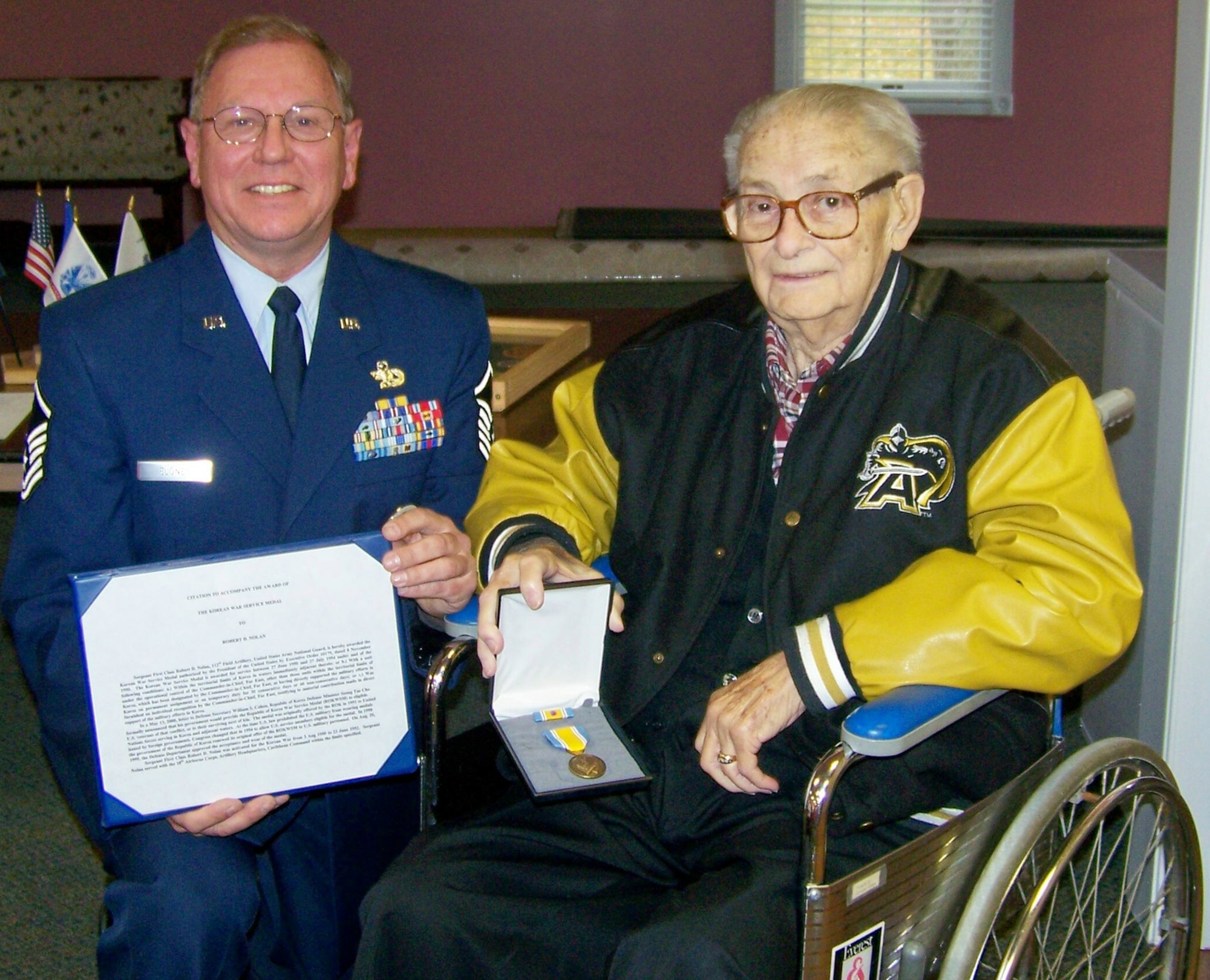 CORTLAND, Ohio — Air Force Reserve Master Sgt. Dave Elonen, an avionics technician in the 910th Maintenance Squadron, honors war veteran former Army Sgt. 1st Class Robert Nolan with the presentation of the Korean War Service Medal.  Courtesy Photo.