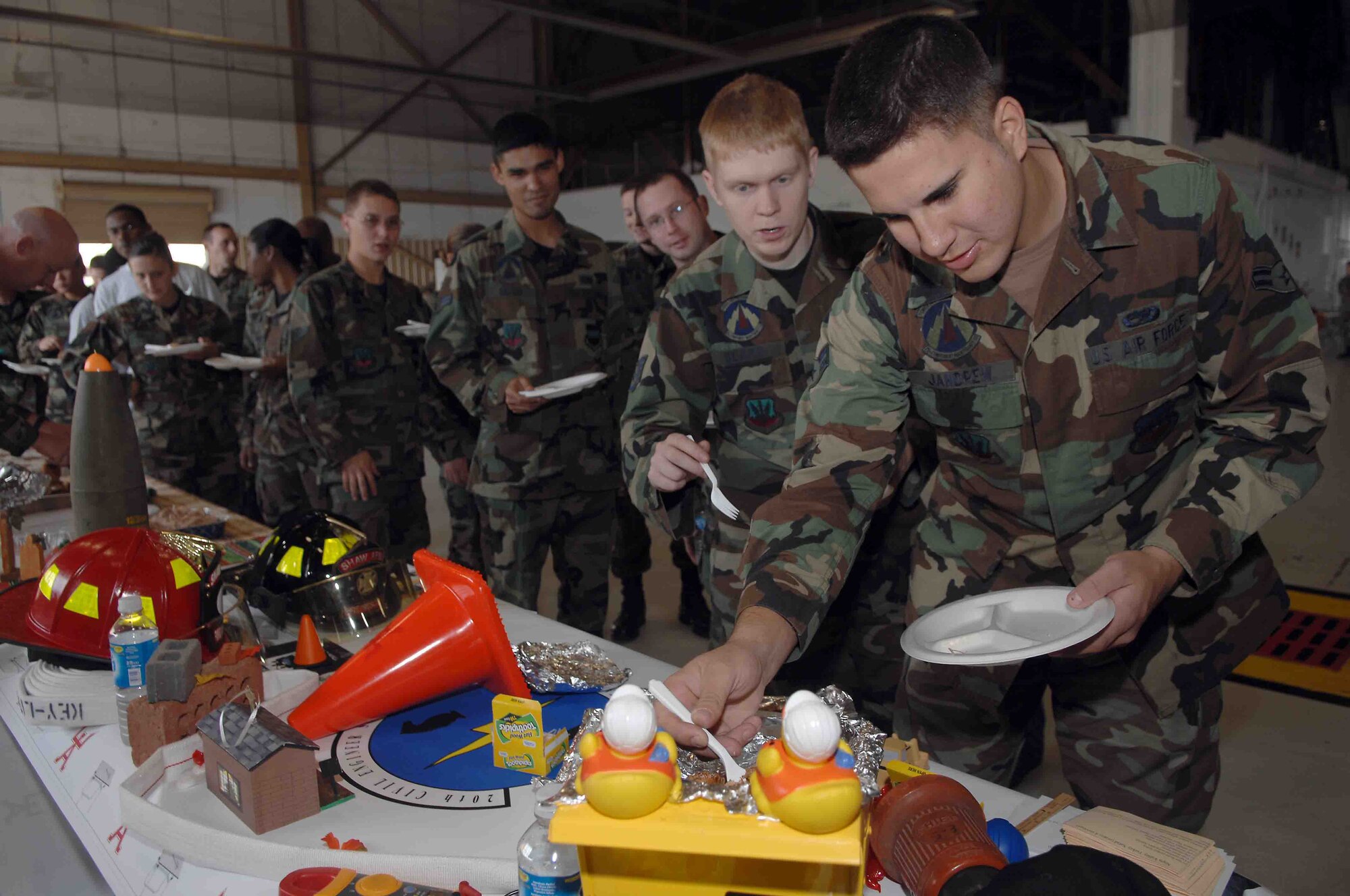 SHAW AIR FORCE BASE, S.C. -- Airman 1st Class Logan Jandrew and Staff Sgt. Kyle Beard, 20th Component Maintenance Squadron, grab some cajun marinated turkey from the 20th Civil Engineer Squadron turkey booth, Nov. 21 during the Turkey Tasting contest. The Turkey Tasting contest was a way for Shaw to celebrate the Thanksgiving holiday. (U.S. Air Force photo/Staff Sgt. Nathan Bevier)