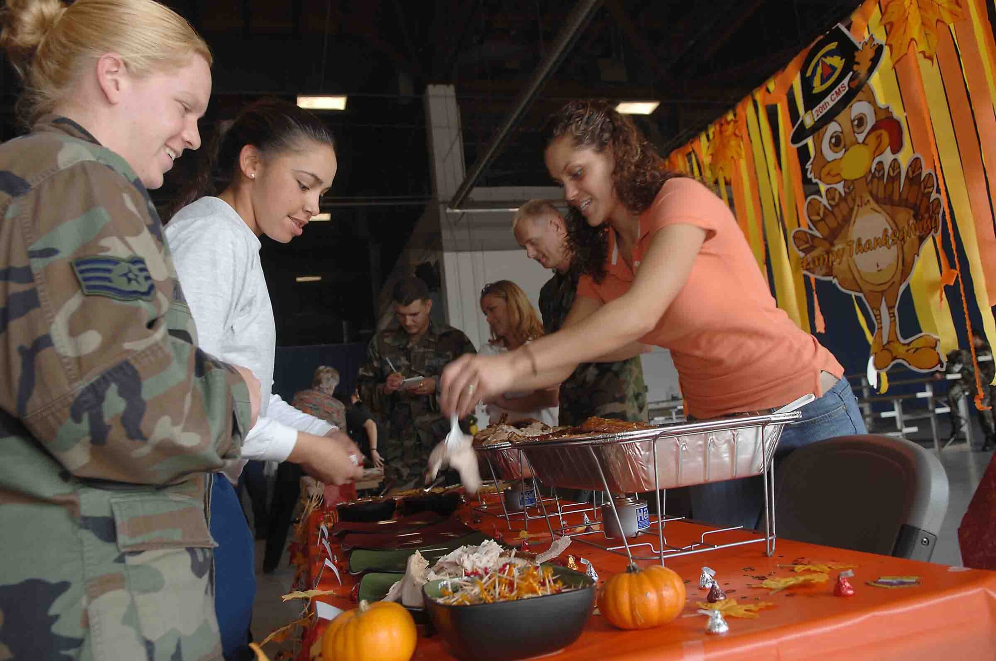 SHAW AIR FORCE BASE, S.C. -- Senior Airman Dominique Cooper, 20th Component Maintenance Squadron, hands out pieces of turkey to Senior Airman Tanya McGrady and Staff Sgt. Mindy Altum, 20th CMS, Nov. 21 during the Turkey Tasting contest. The Turkey Tasting contest was a way for Shaw to celebrate the Thanksgiving holiday. (U.S. Air Force photo/Staff Sgt. Nathan Bevier)