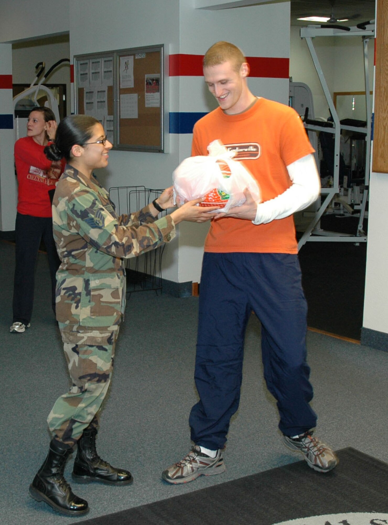 Staff Sgt. Sonia Bustamante, 341st Services Squadron, hands 1st Lt. Joe Schneider, 741st Missile Security Forces Squadron, a turkey following his second place finish in the male division of the annual Turkey Trot 5K race at Malmstrom Nov. 15.
First and second place finishers in the male and female divisions won frozen turkeys.
1st Lt. Sayuri Cash, 341st Missile Maintenance Squadron, won first place in the female division with a time of 27:00.
Amy Kingfisher took second with a time of 27:25;
Tech. Sgt. Randy Kingfisher, 341st Maintenance Operations Squadron, won first place in the male division with a time of 22:33; and
Lieutenant Schneider came in second with a time of 23:08. (U.S. Air Force photo/Airman 1st Class Dillon White)
