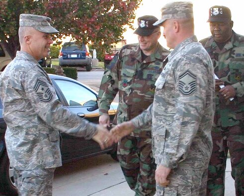 Chief Master Sgt. Todd A. Kabalan, left, is greeted by senior enlisted personnel from the 552nd Communications Group during his early morning visit to their facility. The 8th Air Force command chief visited Tinker Nov. 14-16. (Air Force photo by 2nd Lt. Kinder Blacke)