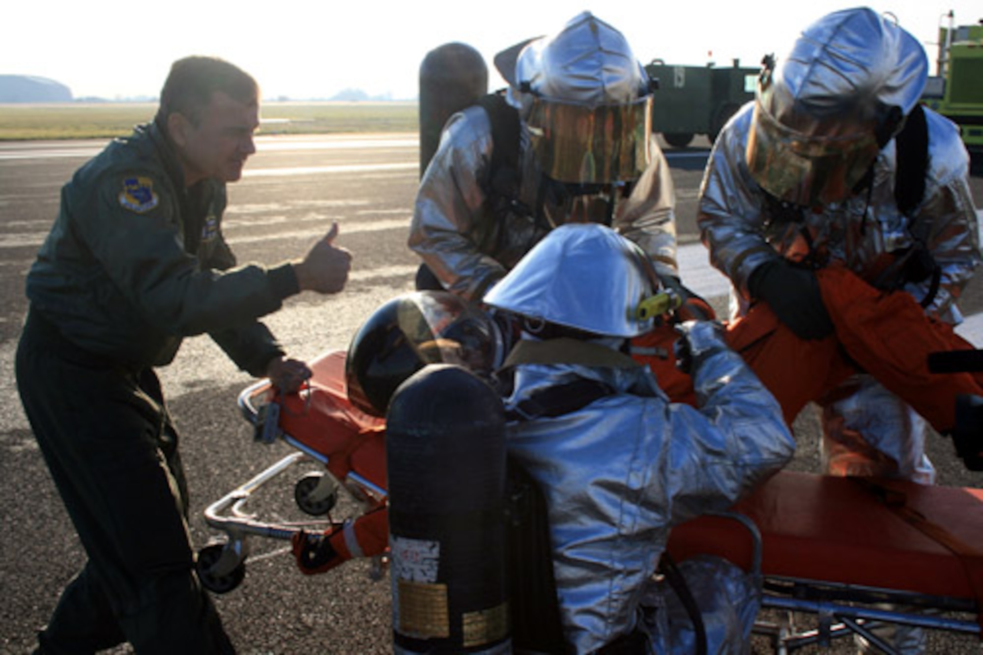 Lt. Col. (Dr.) Tom Hoffman gives the thumbs-up to firefighters during a space shuttle recovery exercise Nov. 16. Royal Air Force Fairford, United Kingdom, is one of nine alternate landing sites for the space shuttle. If the launch was aborted, Airmen from the 420th Air Base Group would lead the rescue and recovery efforts. Colonel Hoffman is a flight doctor assigned to the 45th Space Wing at Patrick Air Force Base, Fla. The next shuttle launch is scheduled for Dec. 6. (U.S. Air Force photo/Tech. Sgt. Kristina Barrett)