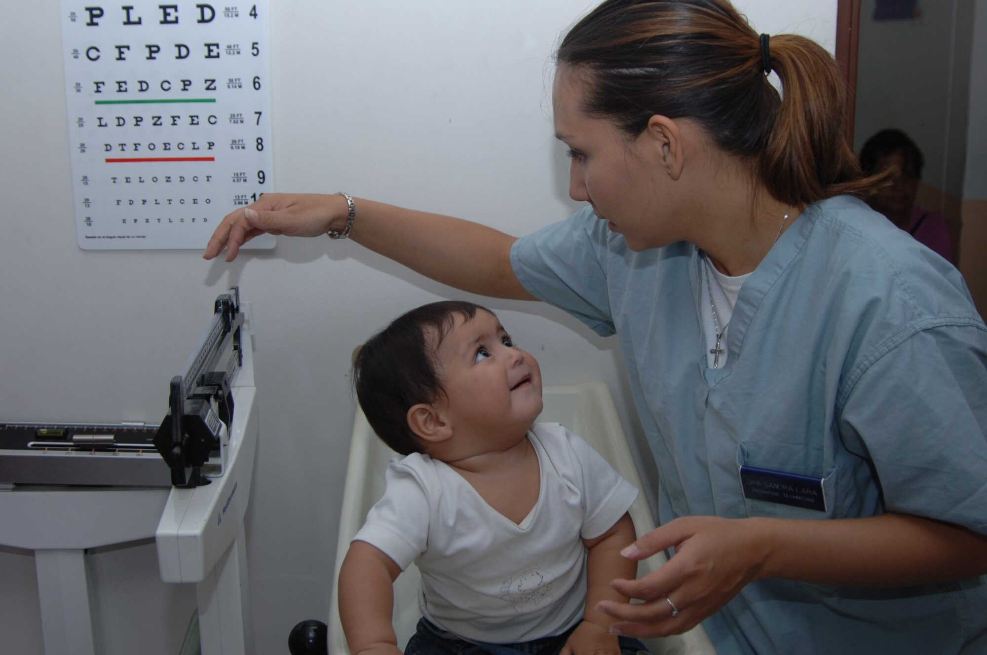Senior Airmen Sandra Lara, 59th Surgical Operations Squadron, evaluates the weight of a Colombian toddler during a 14-member medical team deployment to Popayan, Colombia where they provided comprehensive medical care to more than 4,000 impoverished Colombian citizens. Colombian President Alvaro Uribe recognized the combined efforts of Airmen, Soldiers, Sailors and Marines during a ceremony in Bogota, Colombia, Nov. 14th, where he presented the “Air Force Cross for Aeronautical Merit — Grand Cross Category” medal to Lt. Gen. Norman Seip, 12th Air Force and Air Forces Southern commander.  General Seip accepted the award on behalf of the hundreds of military members who have deployed to Colombia to support humanitarian, military cooperation and counter-narcotics missions.