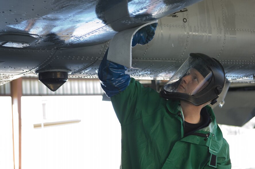 MOODY AIR FORCE BASE, Ga. -- Airman 1st Class Joshua Norris, 23rd Aircraft Maintenance Squadron A-10C Thunderbolt II crew chief, washes the under-belly of his aircraft Nov 19 at Moody Air Force Base, GA. The A-10C Thunderbolt receives a thorough wash-down and lubrication every three months to prevent corrosion and to inspect for surface damage. (U.S. Air Force Photo by Senior Airman Elizabeth Rissmiller)