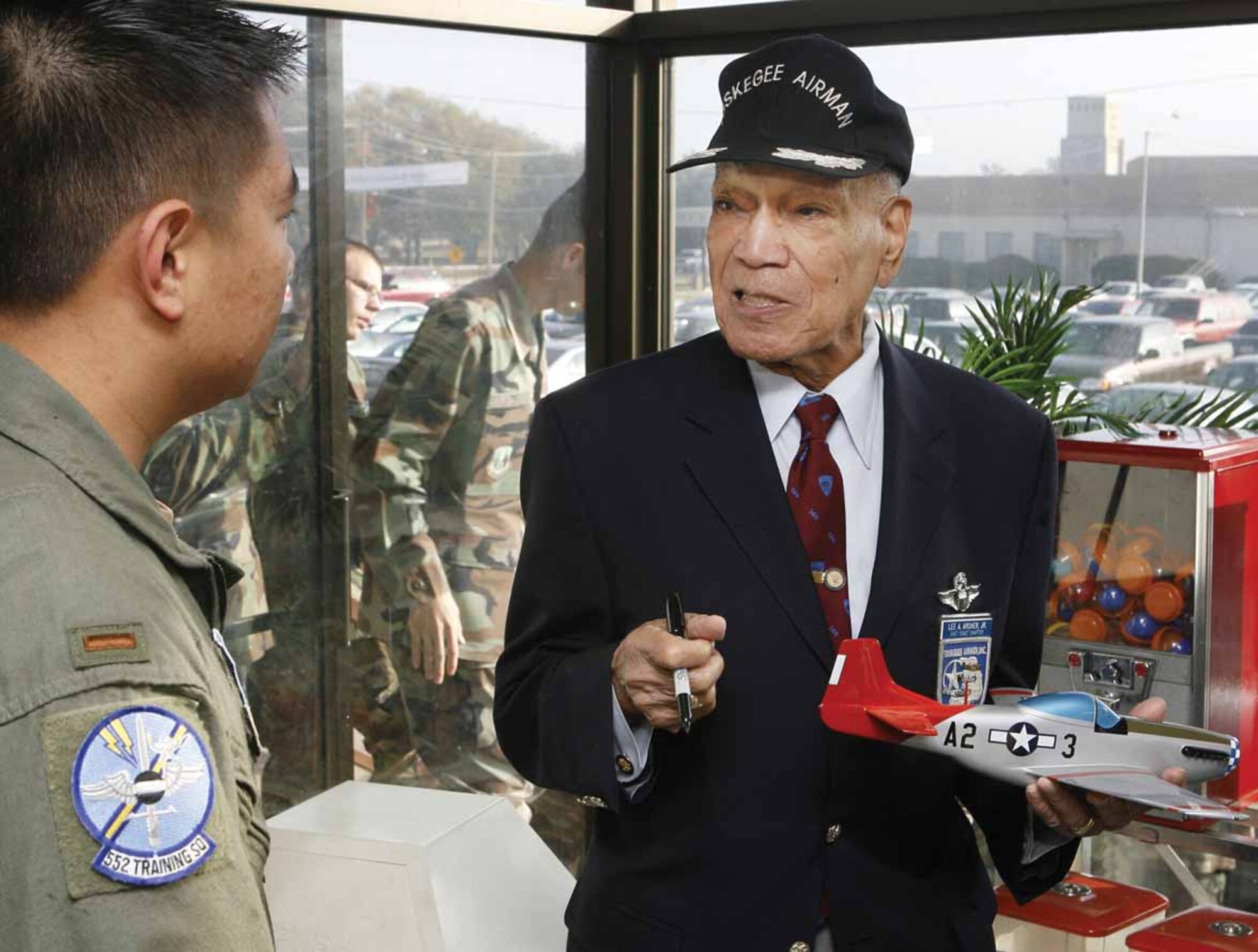Retired Lt. Col. Lee “Buddy” Archer talks to a Tinker Airman during Wingman Day. The World War II ace with five confirmed enemy kills spoke to Tinker Airmen about the importance of having a wingman, both in the air and on the ground. (Photo by Paul Hellstern, The Oklahoman)