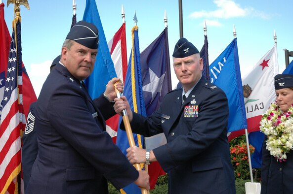 Maj. Gen. Robert E. Duignan, 4th Air Force Commander, passes the 624th Regional Support Group's guidon to Col. John L. Morris during the change of command ceremony at Hickam AFB, Hawaii.  (U.S. Air Force photo/Staff Sgt. Jennifer Chamberlin)