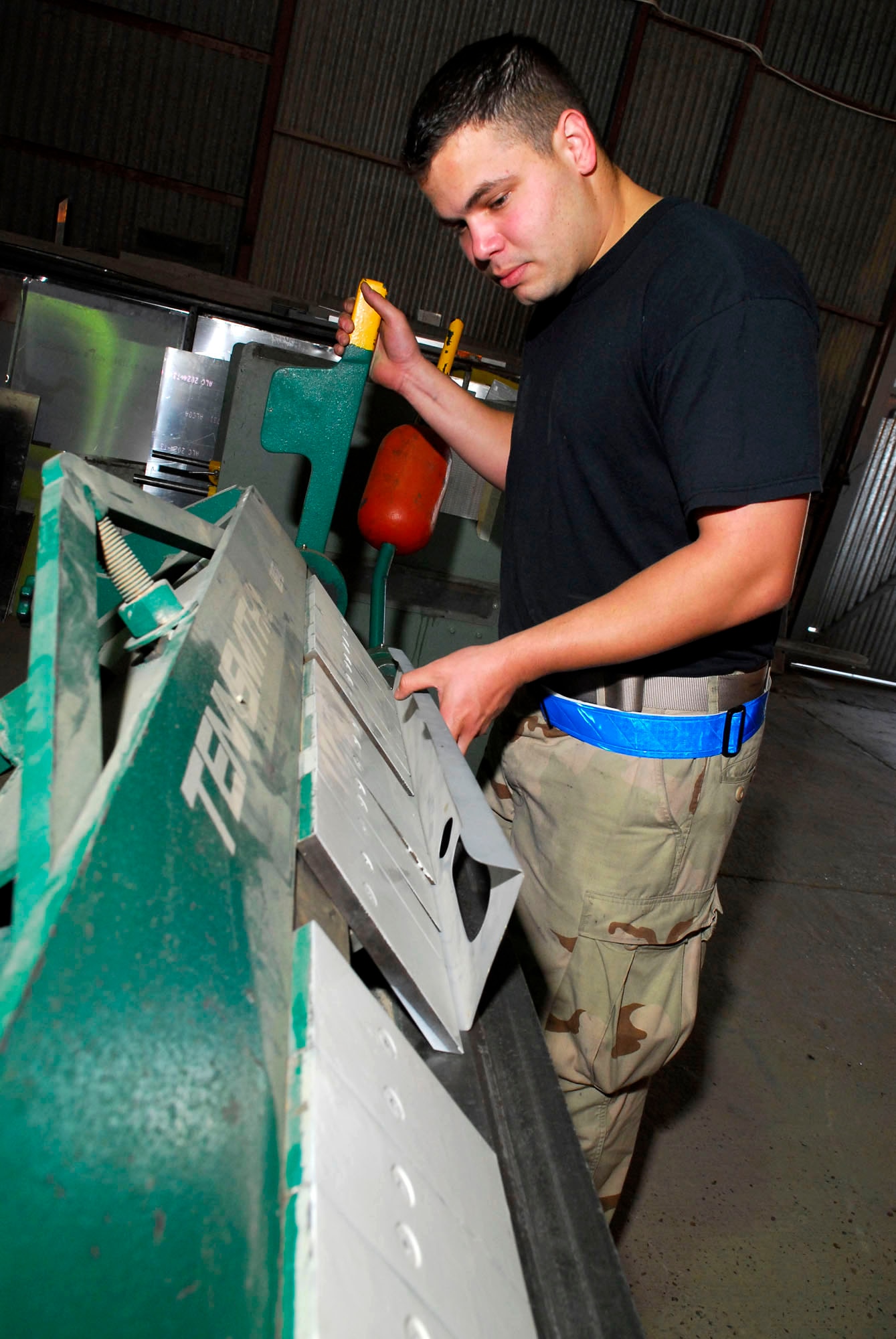 Staff Sgt. Adrian Lopez uses a box and pan break to create a strake enclosure rib which will be used on an F-16 Fighting Falcon Nov. 14 at Balad Air Base, Iraq. The box and pan break bends metal at a ninety-degree angle helping the sheet fabrication shop meet the needs of all customers. Sergeant Lopez is a 332nd Expeditionary Maintenance Squadron aircraft structural maintainer and is deployed from Spangdahlem Air Base, Germany. (U.S. Air Force photo/Staff Sgt. Joshua Garcia) 