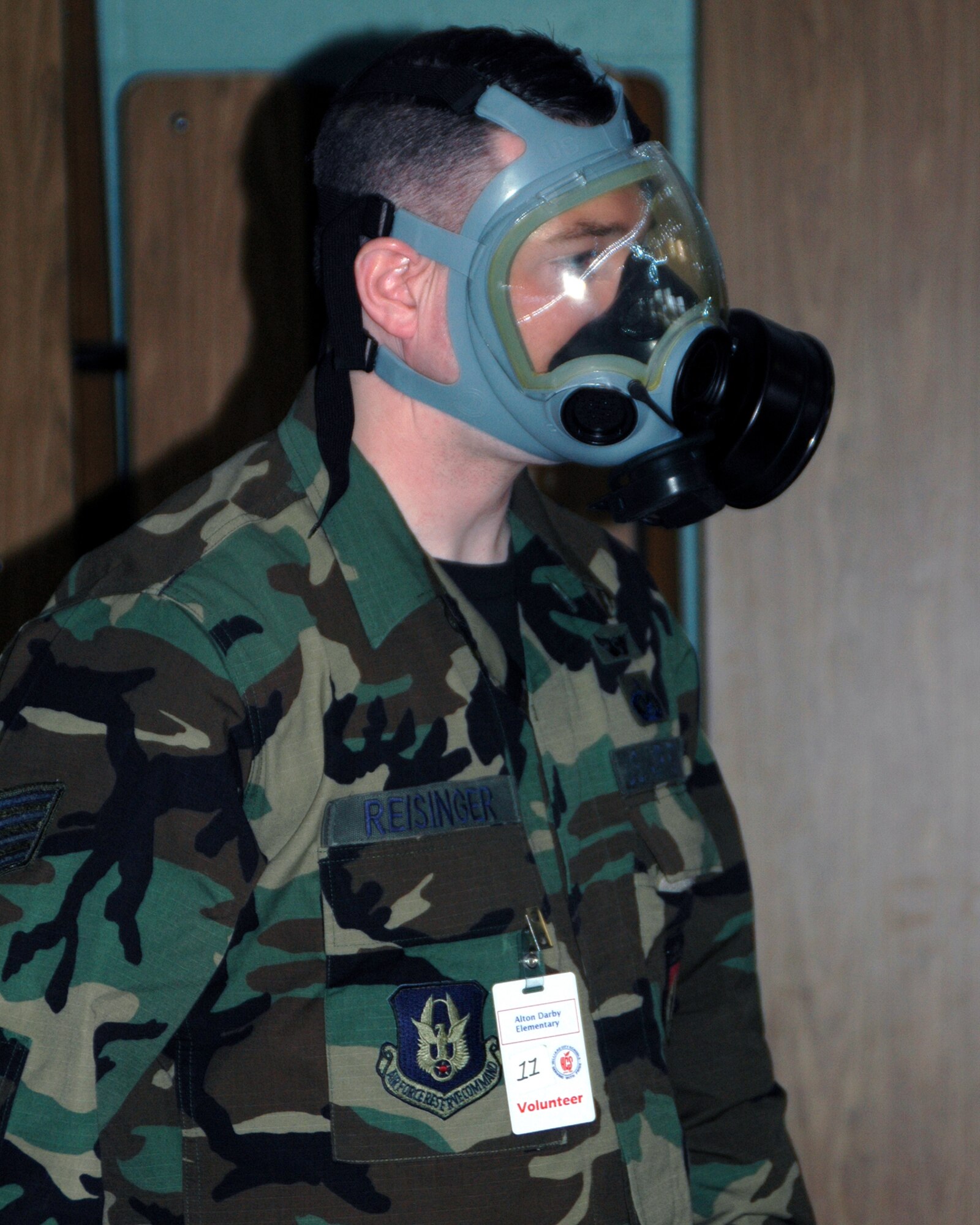 Staff Sgt. Terry Reisinger, chaplain assistant with the 445th Airlift Wing, demonstrates his gas mask while speaking to the 4th and 5th graders from Alton Darby Elementary School, Hilliard, Ohio on Veteran's Day, Nov. 12, 2007.  