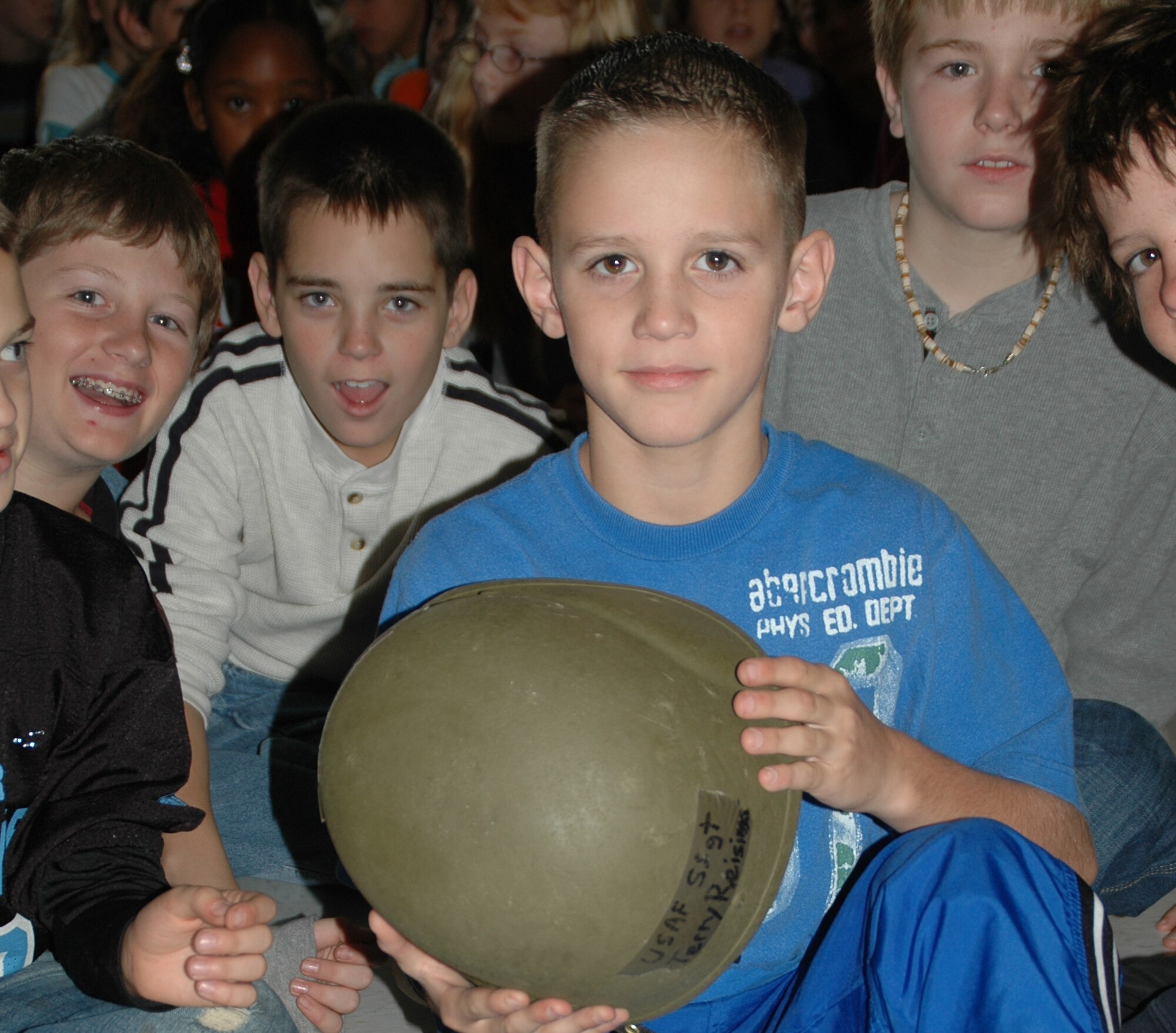 A 5th grader from Alton Darby Elementary School in Hilliard, Ohio, examines a helmet belonging to Staff Sgt. Terry Reisinger, chaplain assistant with the 445th Airlift Wing.  Sergeant Reisinger spoke to the 4th and 5th graders at the school on Veteran's Day, Nov. 12, 2007.  