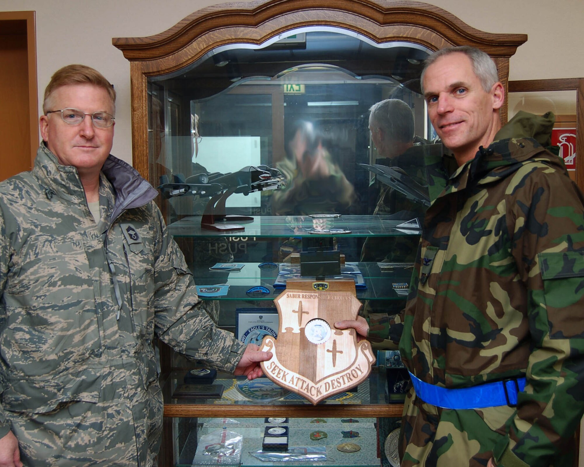 SPANGDAHLEM AIR BASE, Germany-- Col. Thomas Lawhead, 52nd Operations Group commander, and Chief Master Sgt. Mark Greatorex, 52nd OG, received their unit's responsible choices coin back from the base commander for going 30 days without a unit member having alcohol related incident or driving under the influence accident. (U.S. Air Fore Photo/Staff Sgt. Chris Mills)