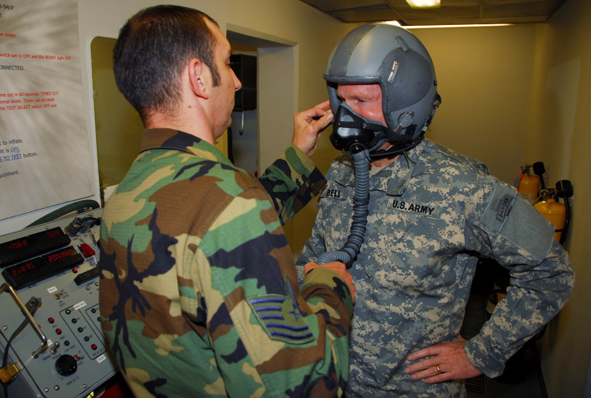OSAN AIR BASE, Republic of Korea --  Gen. B.B. Bell, commander of U.S. Forces Korea, is assisted by Tech. Sgt. Dustin Ogburn in testing the fit of his oxygen mask here Nov. 16. Sergeant Ogburn, a 36th Fighter Squadron aircrew flight equipment technician, helped General Bell get fitted for his equipment in preparation for the general's upcoming flight in a Republic of Korea Air Force F-16. (U.S. Air Force photo by Staff Sgt. Ronnie Hill)