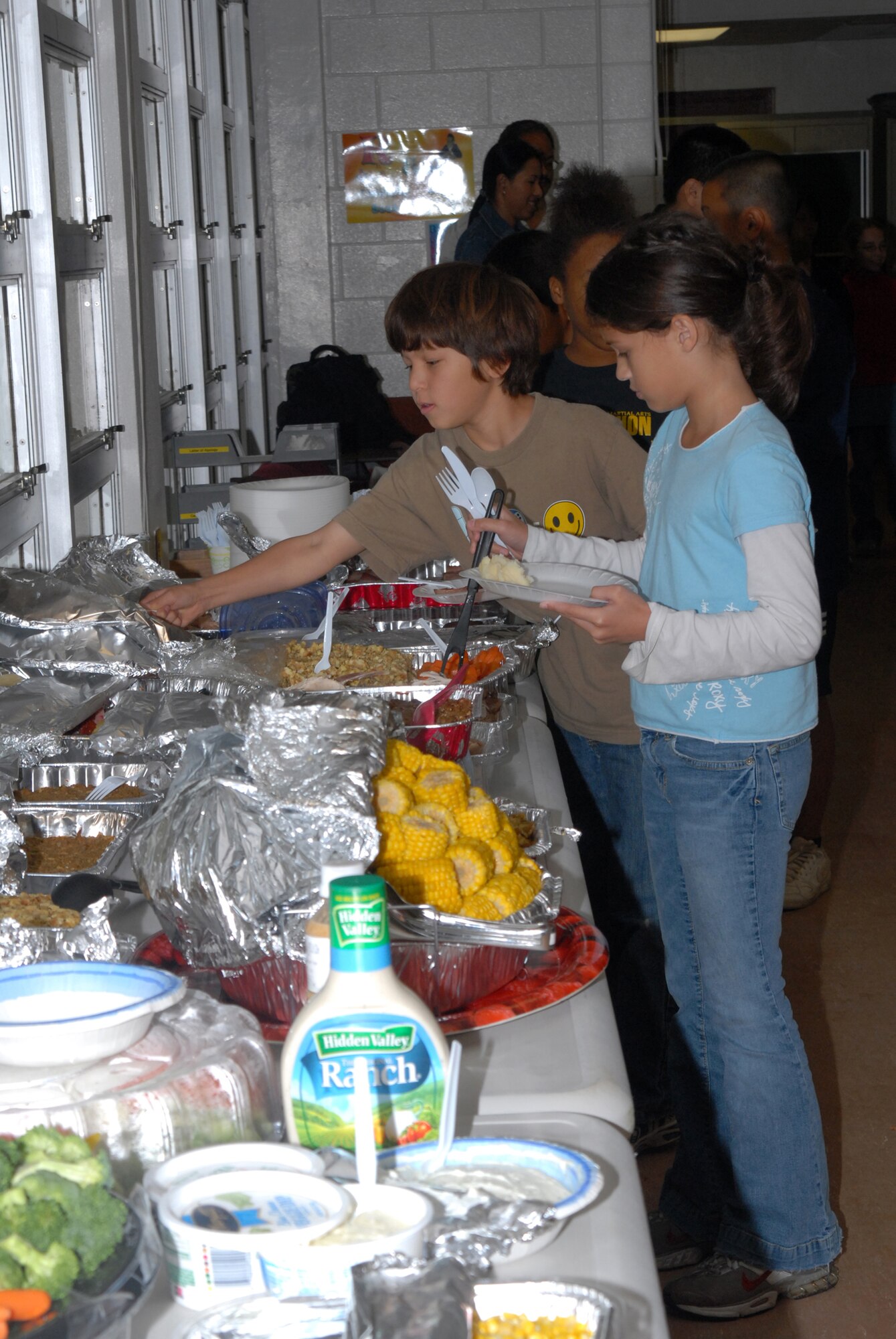 Children line up to get some Thanksgiving turkey with all the fixings during a joint learning experience between American and Japanese children at Kadena Air Base, Japan, Nov. 20, 2007. Kadena Elementary School students shared the American custom of Thanksgiving with students from Yara Elementary School. (U.S. Air Force photo/Airman 1st Class Ryan Ivacic) 