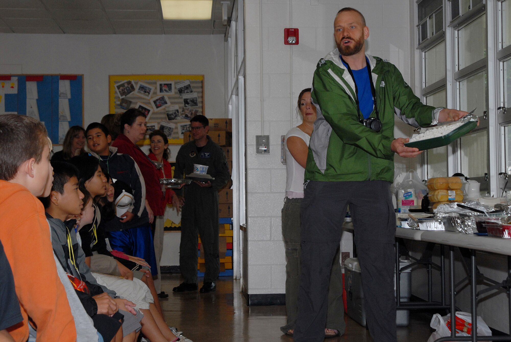 Seth Renquist, a fifth-grade Japanese partial immersion teacher at Kadena Elementary School, explains the different types of Thanksgiving dishes to a group of students during a joint learning experience between American and Japanese children at Kadena Air Base, Japan, Nov. 20, 2007. KES students shared the American custom of Thanksgiving with students from Yara Elementary School. (U.S. Air Force photo/Airman 1st Class Ryan Ivacic) 