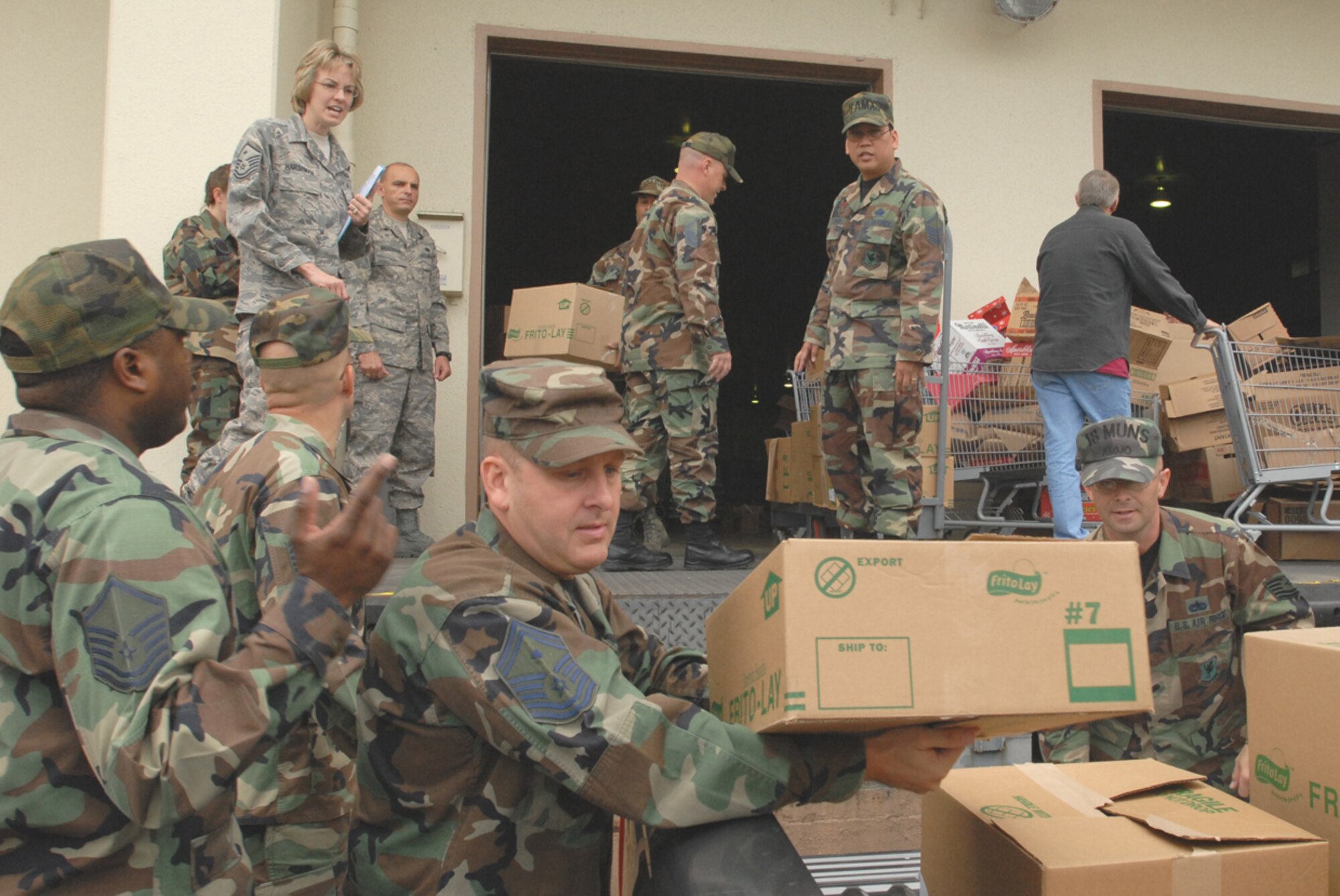 Kadena first sergeants and other Airmen load Thanksgiving food baskets into a truck prior to delivering to enlisted Airmen back in their squadrons Nov. 19. (U.S. Air Force/Airman 1st Class Kasey Zickmund)