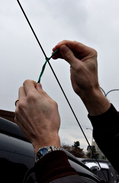 MISAWA AIR BASE, Japan -- A green ribbon is tied onto a car antennae in the Base Exchange parking lot Nov. 21, 2007. The ribbons are part of Misawa's Green Ribbon Campaign, designed to remind Airmen to be safe this holiday season and not drink and drive. (US Air Force photo by Airman 1st Class Eric Harris)
