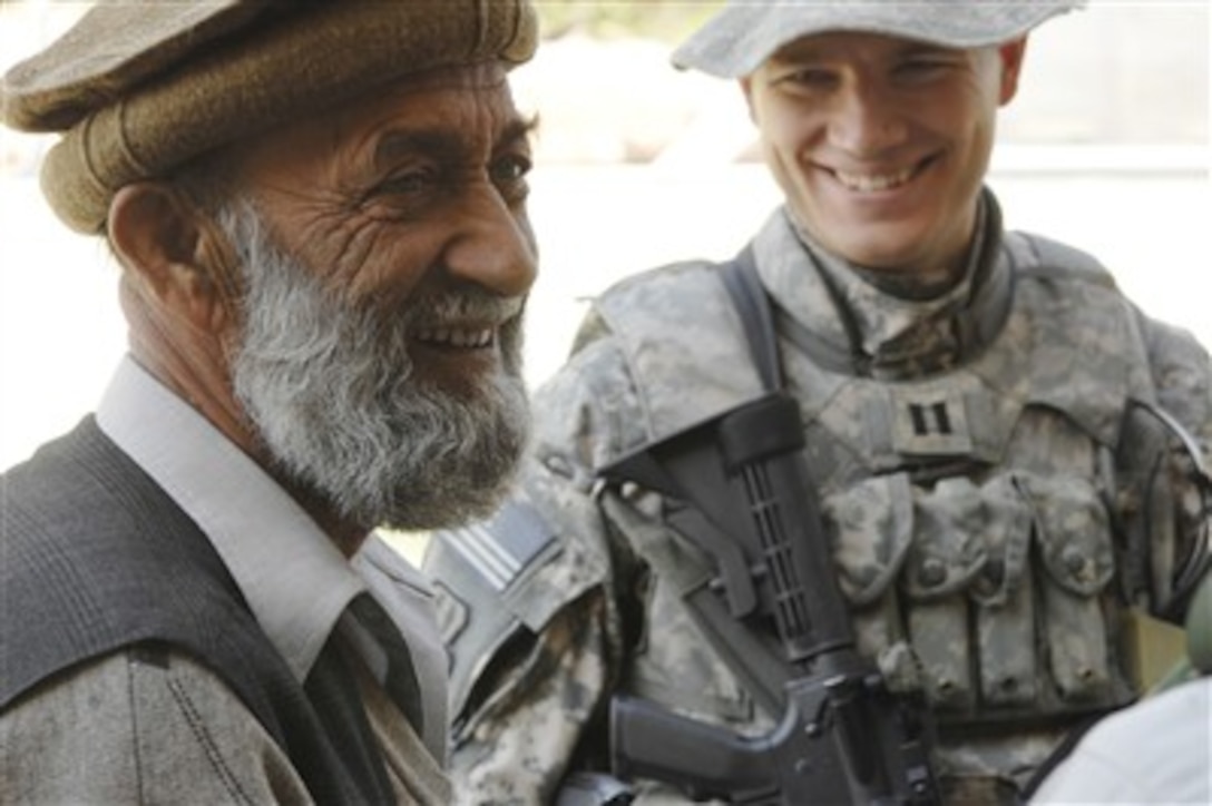 An Afghan engineer talks with U.S. Air Force Capt. Paul Frantz, of the Nangarhar Provincial Reconstruction Team, at a metal working shop in the Nangarhar province of Afghanistan on Nov. 6, 2007.  The team assesses community needs and builds schools, government centers, roads, medical facilities and basic infrastructure throughout the area.  