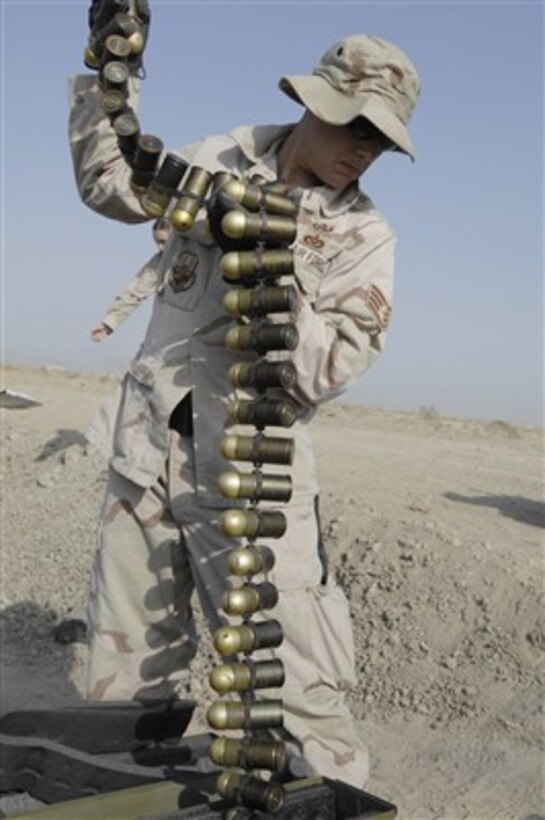 U.S. Air Force Staff Sgt. Anthony Pousen picks up M-430 High Explosive dual-purpose grenade rounds from their case on Ali Air Base, Iraq, on Nov. 14, 2007.  Airmen of the 407th Expeditionary Civil Engineer Squadron explosive ordnance disposal team unloaded nearly 1,800 pounds of expired munitions for demolition to ensure they will not be used against U.S. forces.  
