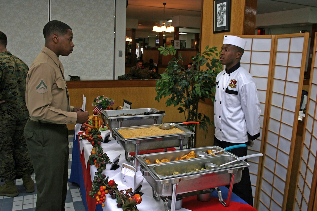 Lance Cpl. Tremaine W. Flagg, food service specialist, responds to questions about how he prepared his meal during the Chef of the Quarter Board at the R. G. Robinson Messhall here Nov. 21.