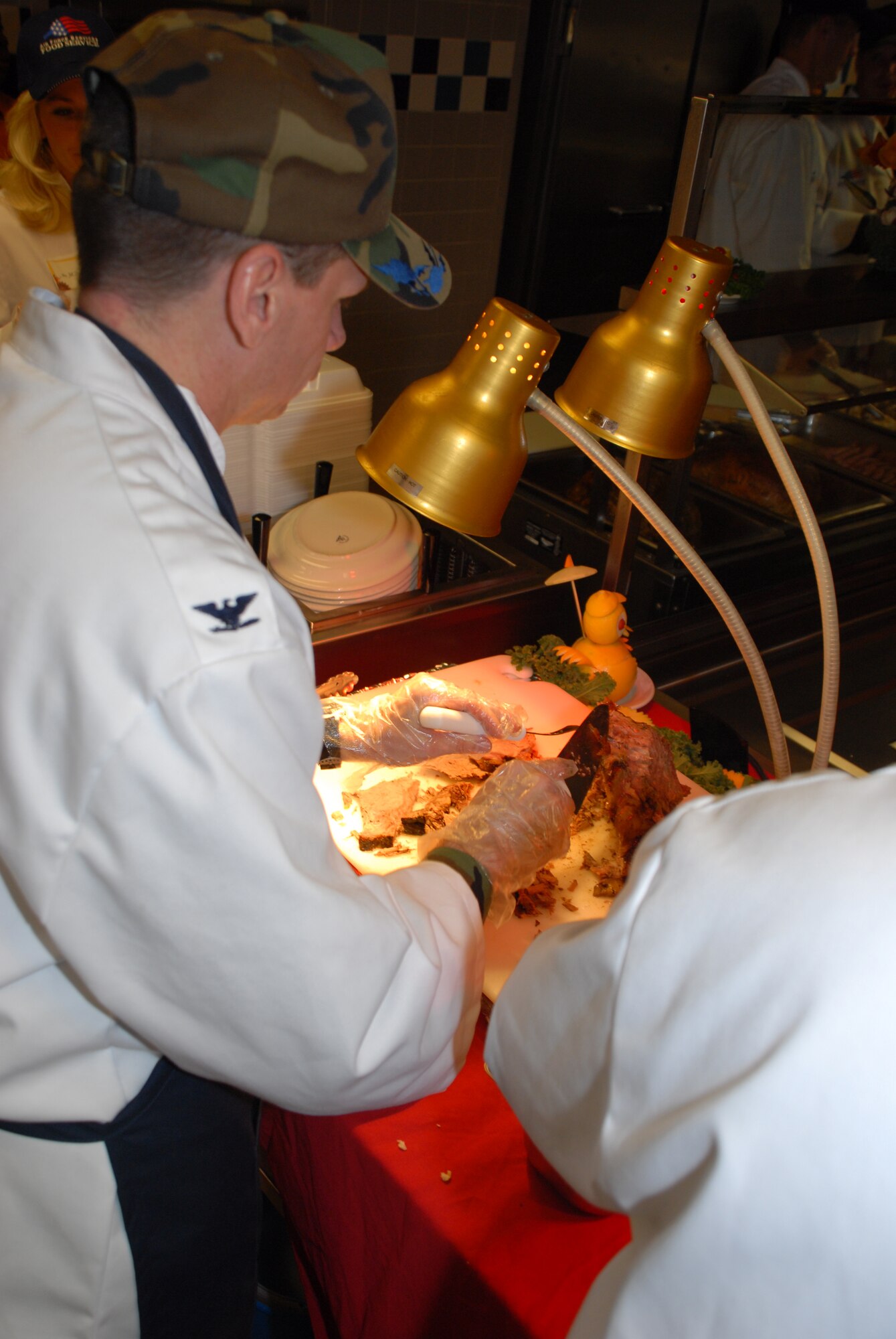 Col. Eric Wydra, 436th Airlift Wing vice commander carves roast beef at the dinner. In all, 140 pounds of turkey, 72 pounds of ham, 125 punds of roast beef and 30 pounds of peeled shrimp was served to the base Airmen. (U.S. Air Force photo/Tech. Sgt. Kevin Wallace)