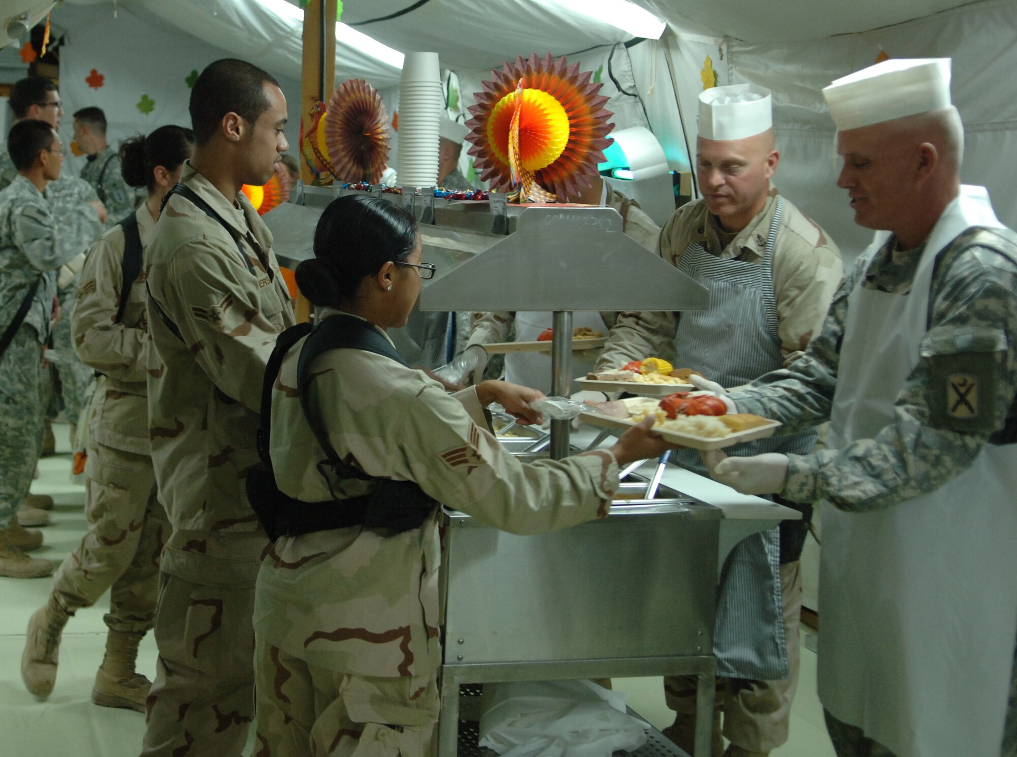FORWARD OPERATING BASE HERO, Afghanistan - Airmen here stand in line to receive their Thanksgiving meal on Nov. 22, 2007. Several enlisted and commissioned leaders here took time to serve meals to  Airmen and Soldiers to show gratitude to their service. (U.S. Air Force photo by Staff Sgt. Mike Andriacco)

