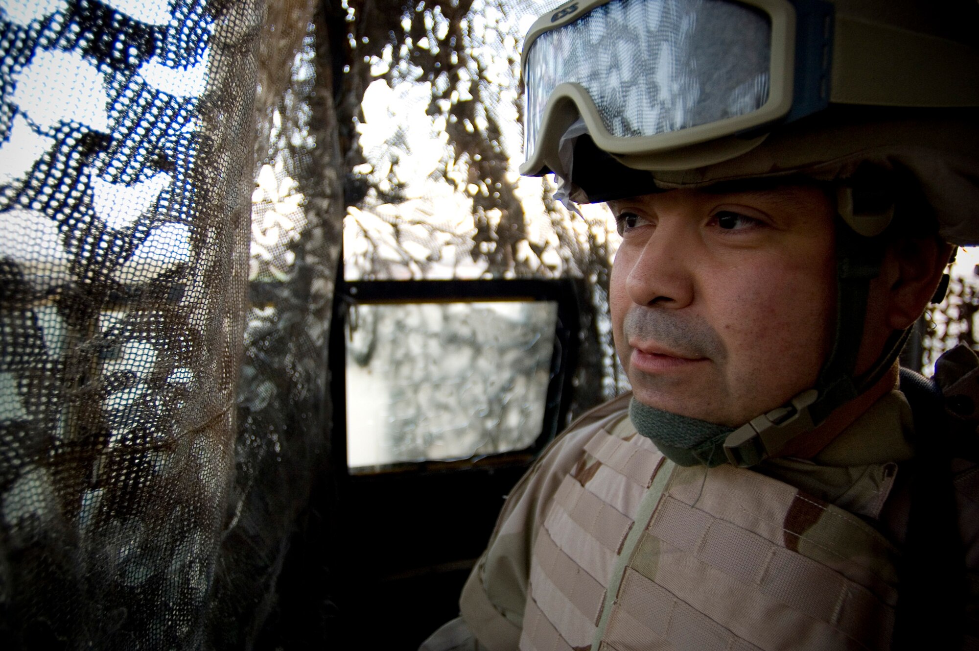 BALAD AIR BASE, Iraq -- Master Sgt. Ronald Roehl, a 332nd Expeditionary Security Forces Squadron alpha flight chief, uses geographic references to scan for possible enemy activity from a century post guarding the flightline here on Nov. 22. Despite being away from his daughters and loved ones, Sergeant Roehl was focused on the mission ensuring his Airmen were prepared for any enemy attack on Air Force personnel or resources. He is deployed from Vogelweh Air Base, Germany. (U.S. Air Force photo/Tech. Sgt. D. Clare)