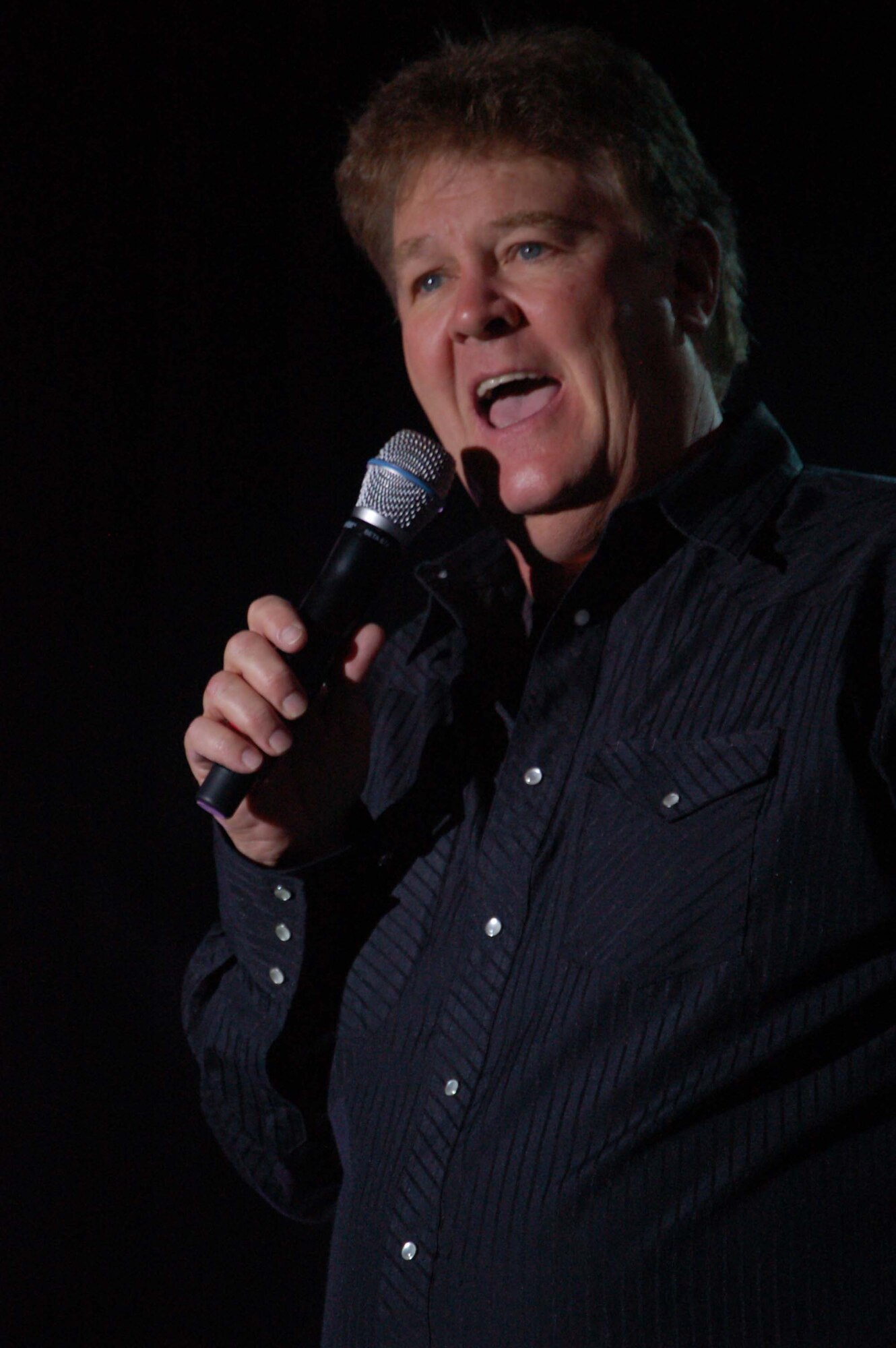 Comedian Dick Hardwick performs a stand up routine at Incirlik Air Base, Turkey. The performance was part of Operation Season's Greetings, an Air Force Reserve Command-sponsored tour designed to bring some down home entertainment and holiday cheer to Airmen overseas. Other performances included latin pop sensation Melina Leon, country music star Jamie O'Neal and the Band of the U.S. Air Force Reserve. (U.S. Air Force photo/Staff Sgt. Matthew Bates)