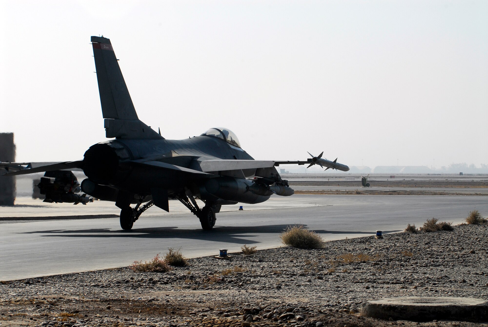 BALAD AIR BASE, Iraq -- Capt. Travis "Bandit" Keenan, a 22nd Expeditionary Fighter Squadron fighter pilot, taxis his F-16 Fighting Falcon to the runway for a mission here, Thanksgiving Day. The 22nd EFS conducts combat missions in support of ground forces operating in Iraq. Captain Keenan is deployed from Spangdahlem AB, Germany. (U.S. Air Force photo/Staff Sgt. Joshua Garcia)