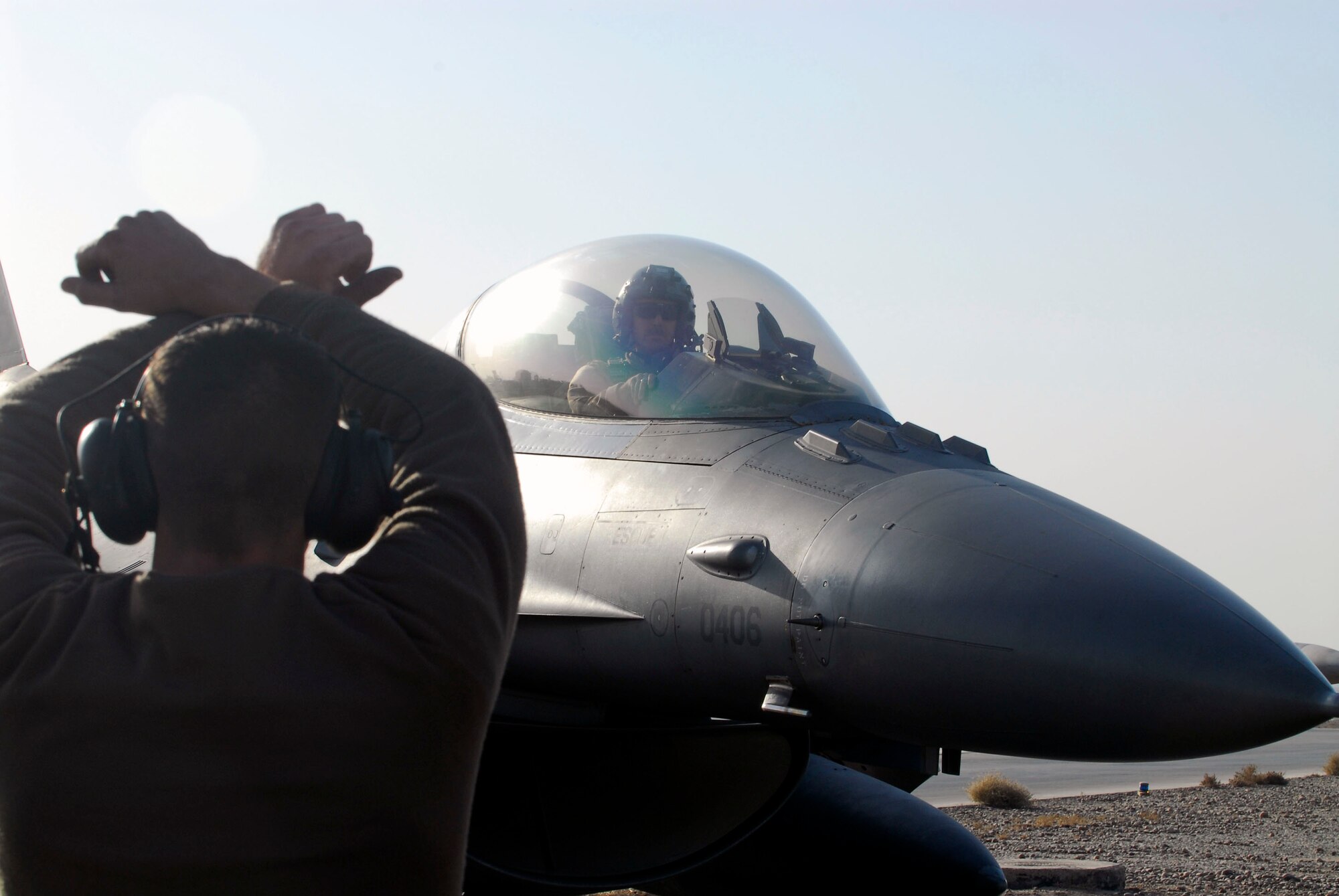 BALAD AIR BASE, Iraq -- Airman 1st Class Matt Reay, a 22nd Aircraft Maintenance Unit crew chief, halts Capt. James "Rider" McCroan, a 22nd Expeditionary Fighter Squadron fighter pilot, after completing a combat mission here, Thanksgiving Day. Airman Reay and Captain McCroan are both deployed from Spangdahlem AB, Germany. (U.S. Air Force photo/Staff Sgt. Joshua Garcia)