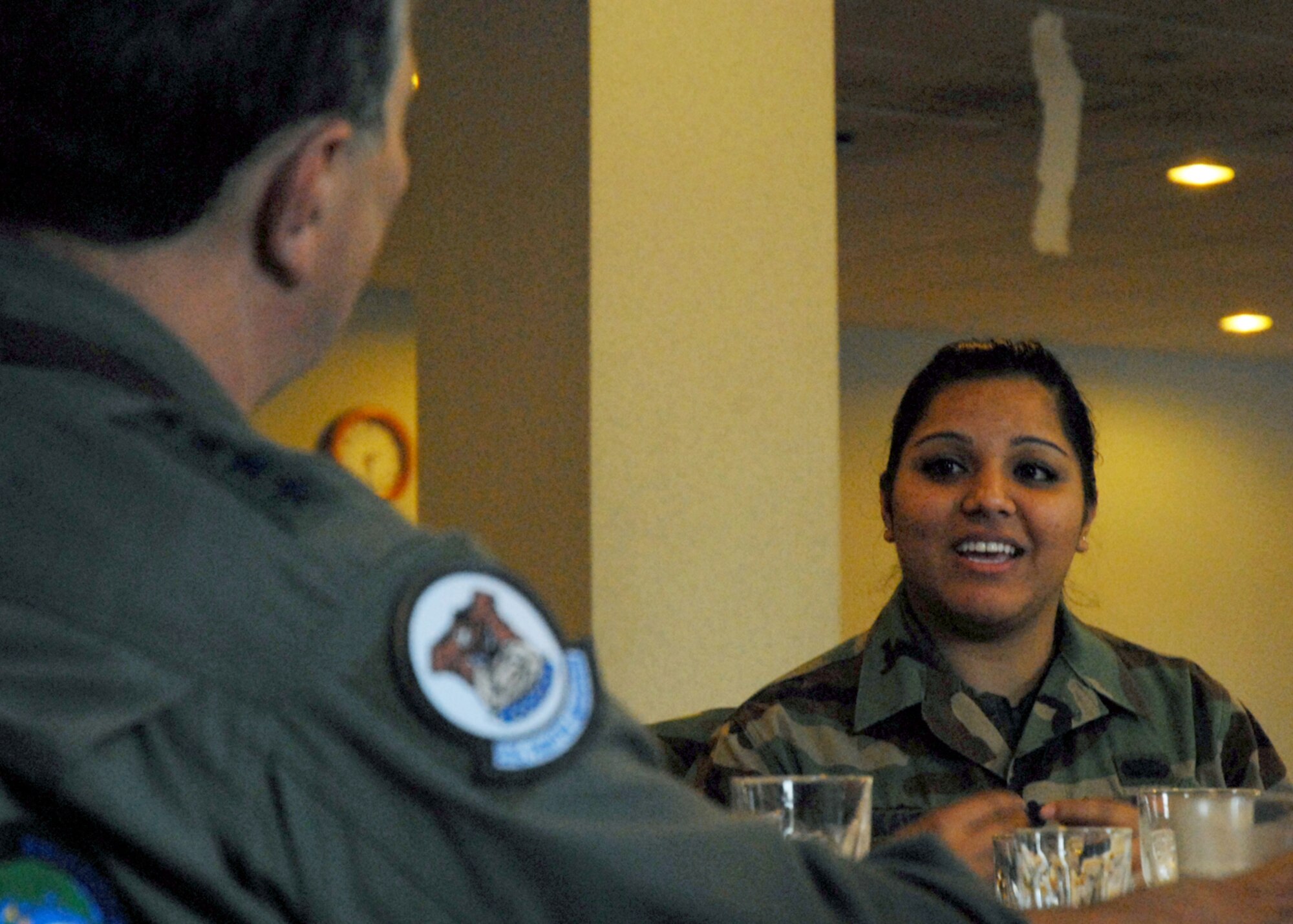 KUNSAN AIR BASE, South Korea—  Gen. Paul V. Hester, Pacific Air Forces commander, talks with Senior Airman Paramjit  Kaur, 8th Services Squadron lodging service representative, about her time in Kunsan and her family over Thanksgiving dinner here Nov. 22. General Hester served and ate Thanksgiving dinner with Airmen stationed at Kunsan to show his appreciation for their service. (U.S. Air Force Photo/Staff Sgt. Araceli Alarcon) 