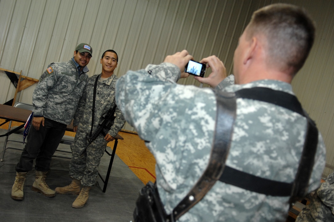 A soldier takes a photo of actor Wilmer Valderrama and Army Spec. John Kahng following a USO show on Camp Liberty in Badghdad, Iraq, Nov. 21, 2007. Valderrama, model Mayra Veronica and comedian Russell Peters are on a USO trip accompanying Vice Chairman of the Joint Chiefs of Staff Marine Corps Gen. James E. Cartwright on a six-day, six-country trip to visit troops in Europe, Asia and Africa.
